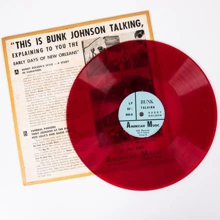 BUNK JOHNSON RED 10 IN. VINYL LP A Bunk Johnson Red 10 in. Vinyl LP from American Music Records, 20th Century, Titled: 'This Is Bunk Johnson Talking, Explaining to You the Early Days of New Orleans' (American Music LP No. 643, red vinyl plastic record). Est: $80 - $120