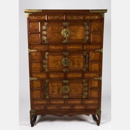 KOREAN THREE LEVEL CLOTHING CHEST A Korean Elm and Burled Wood Three Level Clothing Chest with Brass Mounts, 20th Century. Estimate: $600 - $800