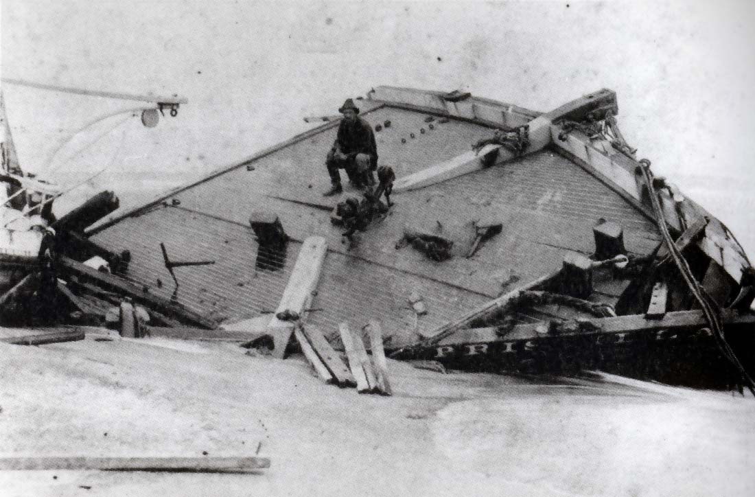 Rasmus Midgett sits on the wreckage of the Priscilla.