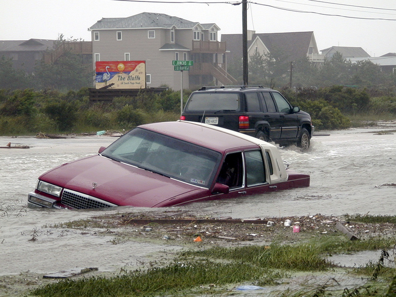 Photo date: September 1, 1999 Photographer: FEMA / Dave Gatley Photo location: Nags Head NC Categories: Hurricane/Tropical Storm Here a car lays flooded out along Old Oregon Inlet Road as the rains and ocean overwash flooded out stretches of the coastal highway. Fifty-plus miles of Highway 12, which leads South from Nags Head to Cape Hatteras and the Hatteras Island, was closed off to traffic due to the sand drifts that covered the coastal highway from ocean overwashes. The change of direction by Dennis brought high seas and winds that battered and flooded the coastal road. Photo by DAVE GATLEY/FEMA News Photo Read more: http://www.city-data.com/disaster-photos/1632.html#ixzz5GnfUnoGA