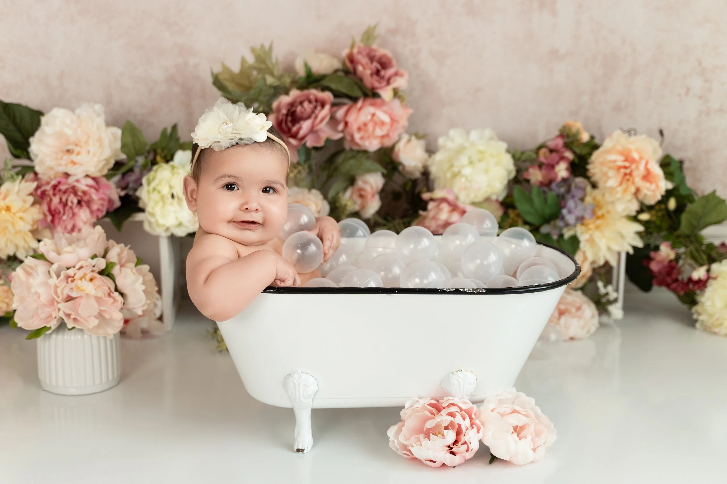 Six month old Presley in a bathtub with bubbles