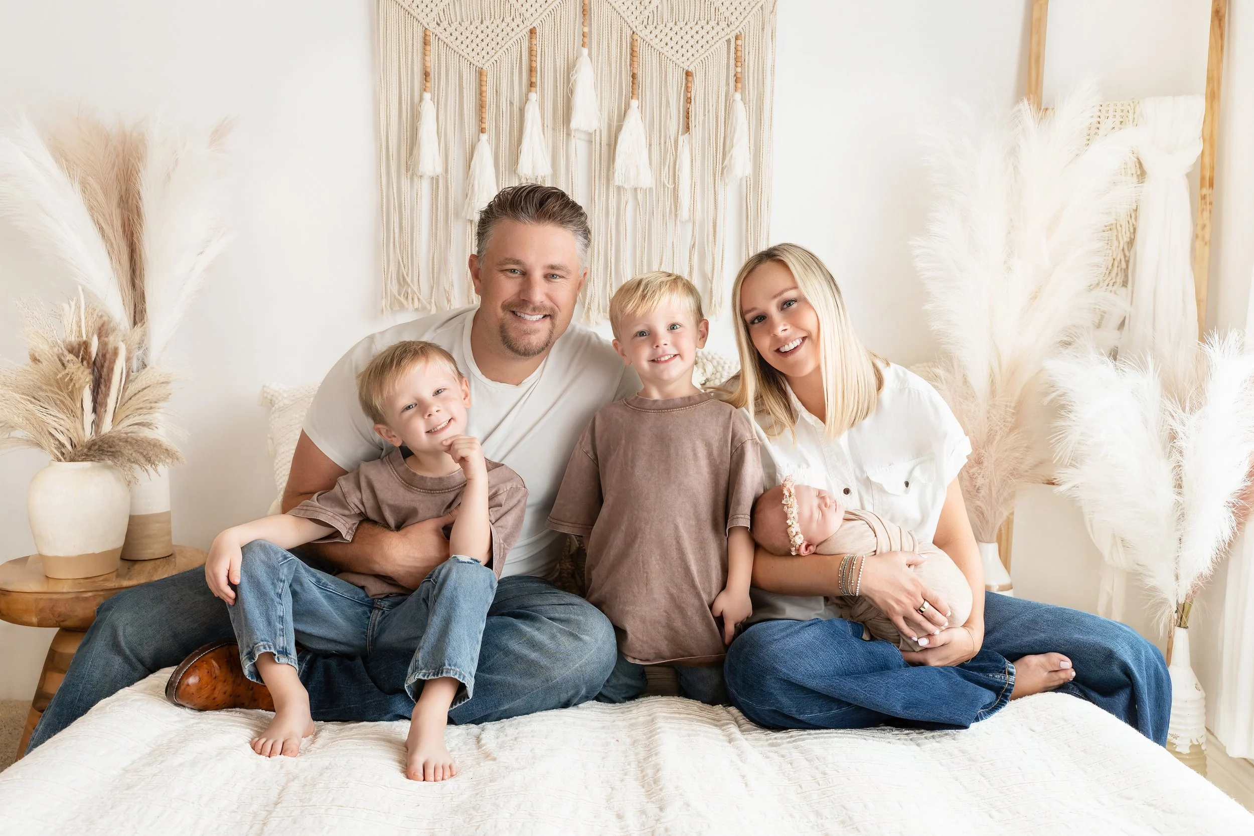 Parents and two big brothers welcome their newborn baby girl during a relaxed family newborn session with Becky K Photography