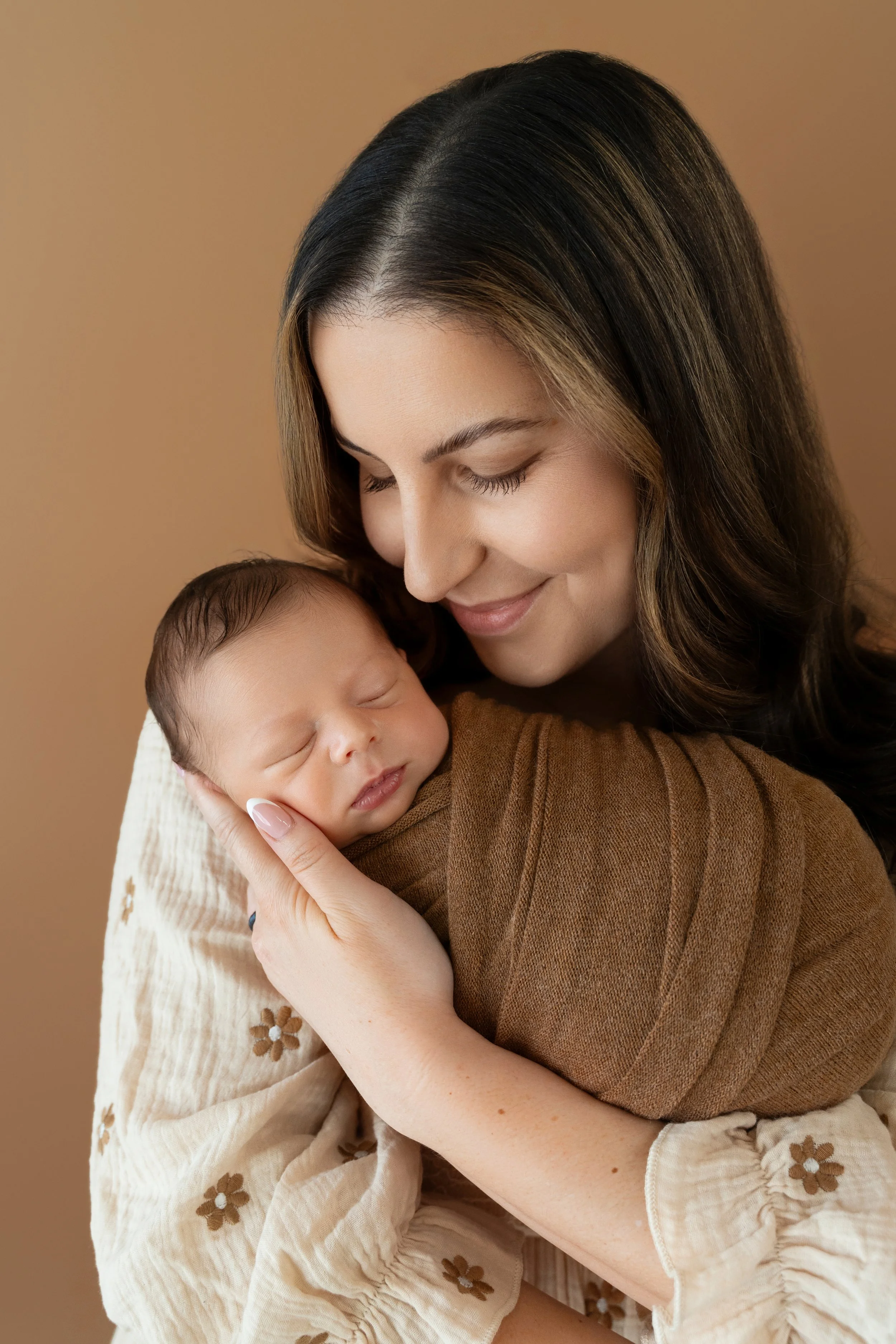 Mom cuddling with 15-day-old baby Archer