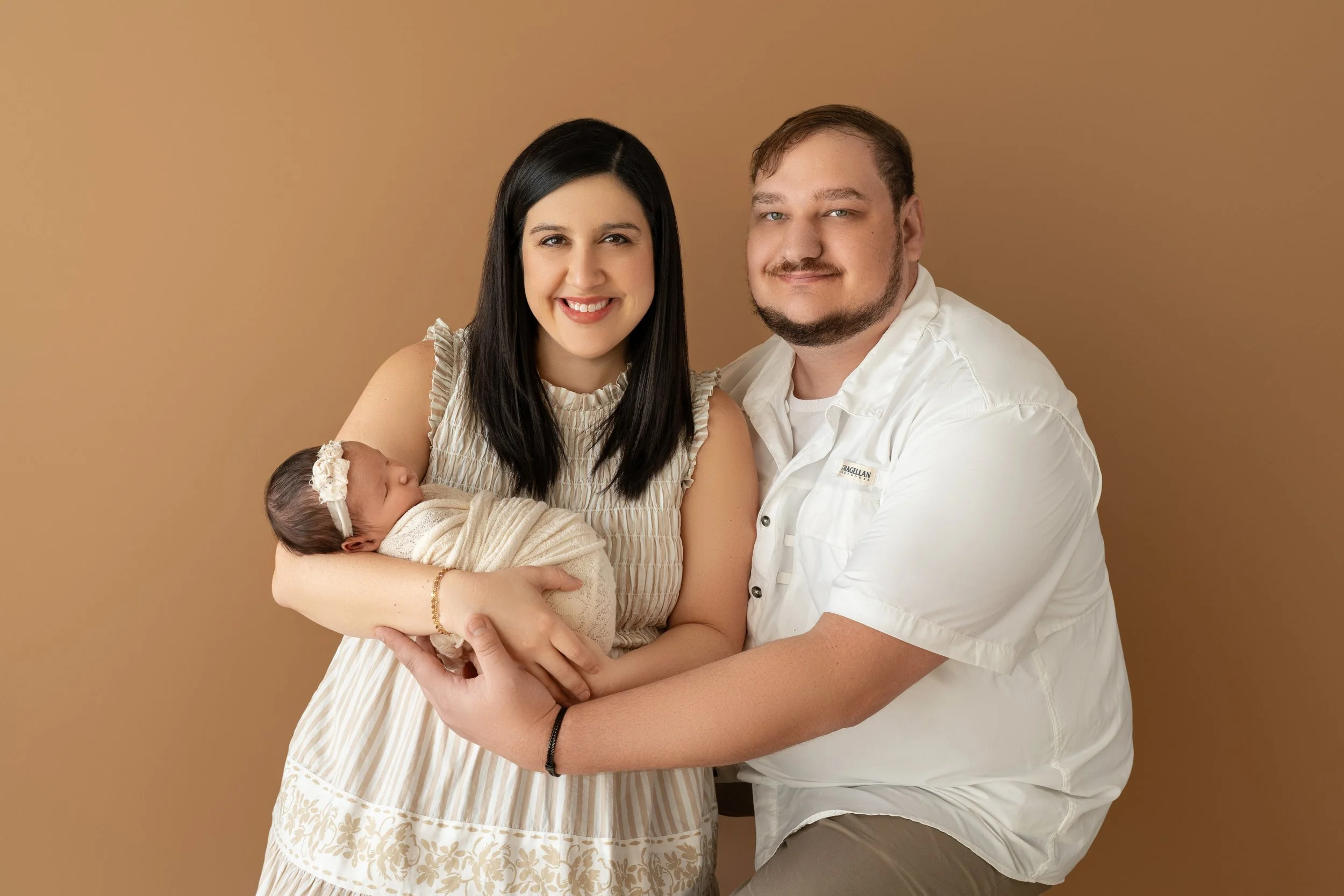 first family photo of mom, dad and newborn baby Presley