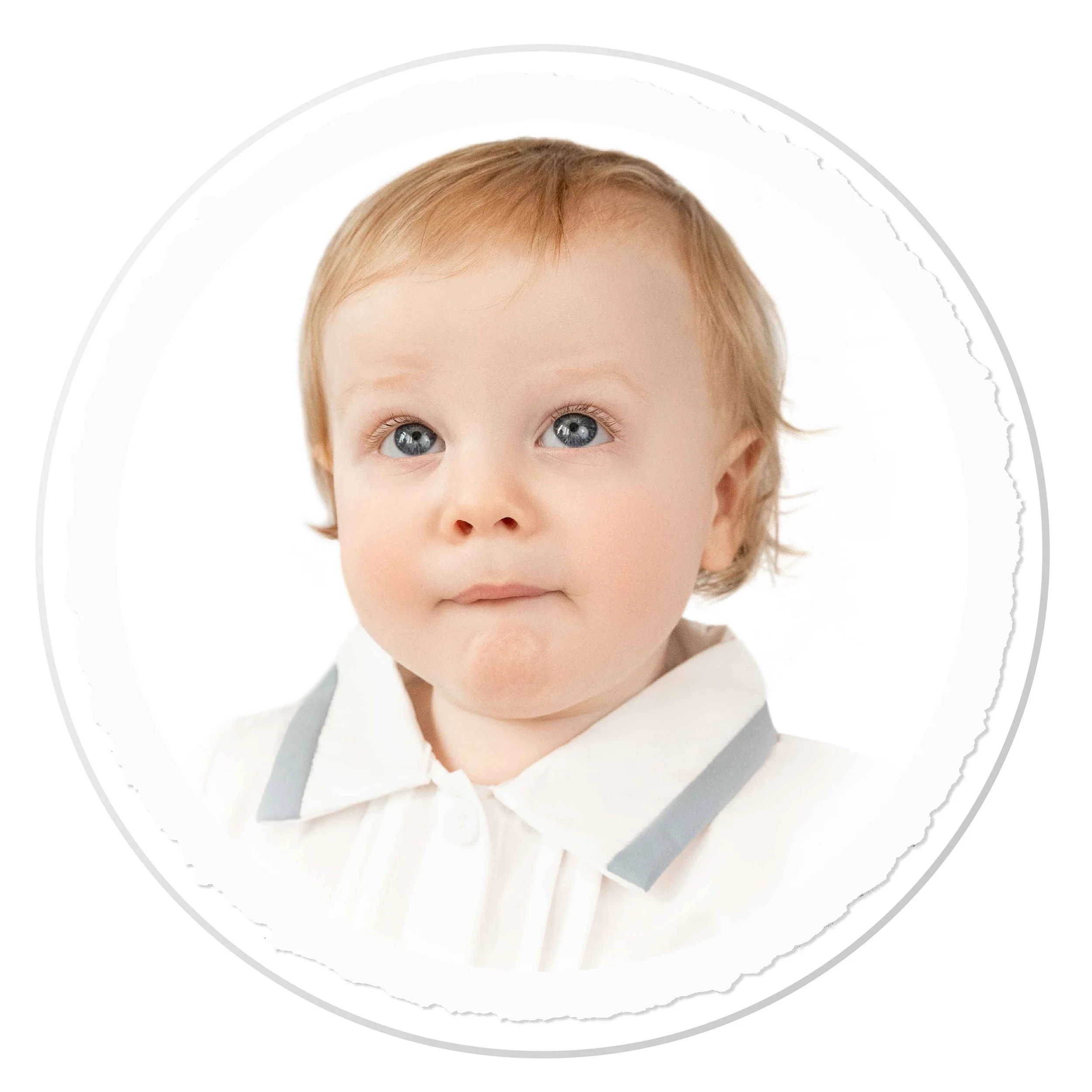 Flat lay of pressed flowers in white frames, a small glass vase with yellow flowers, a sprig of yellow flowers, and a spool of twine on a wooden surface with sunlight and shadows.