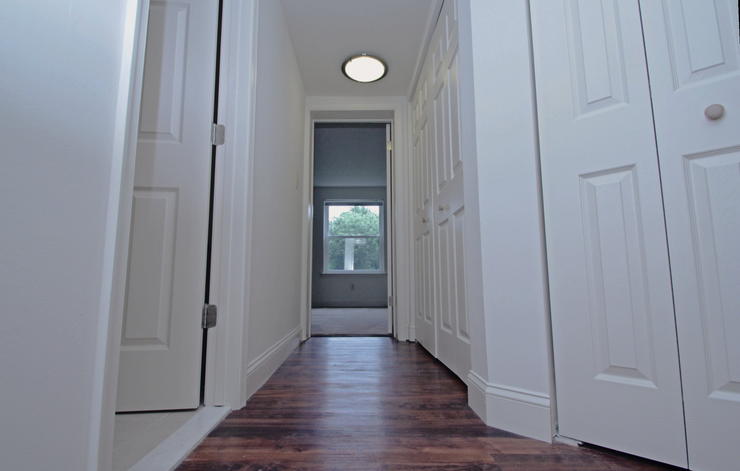 Contemporary Wood Grain Plank Flooring in Hallway