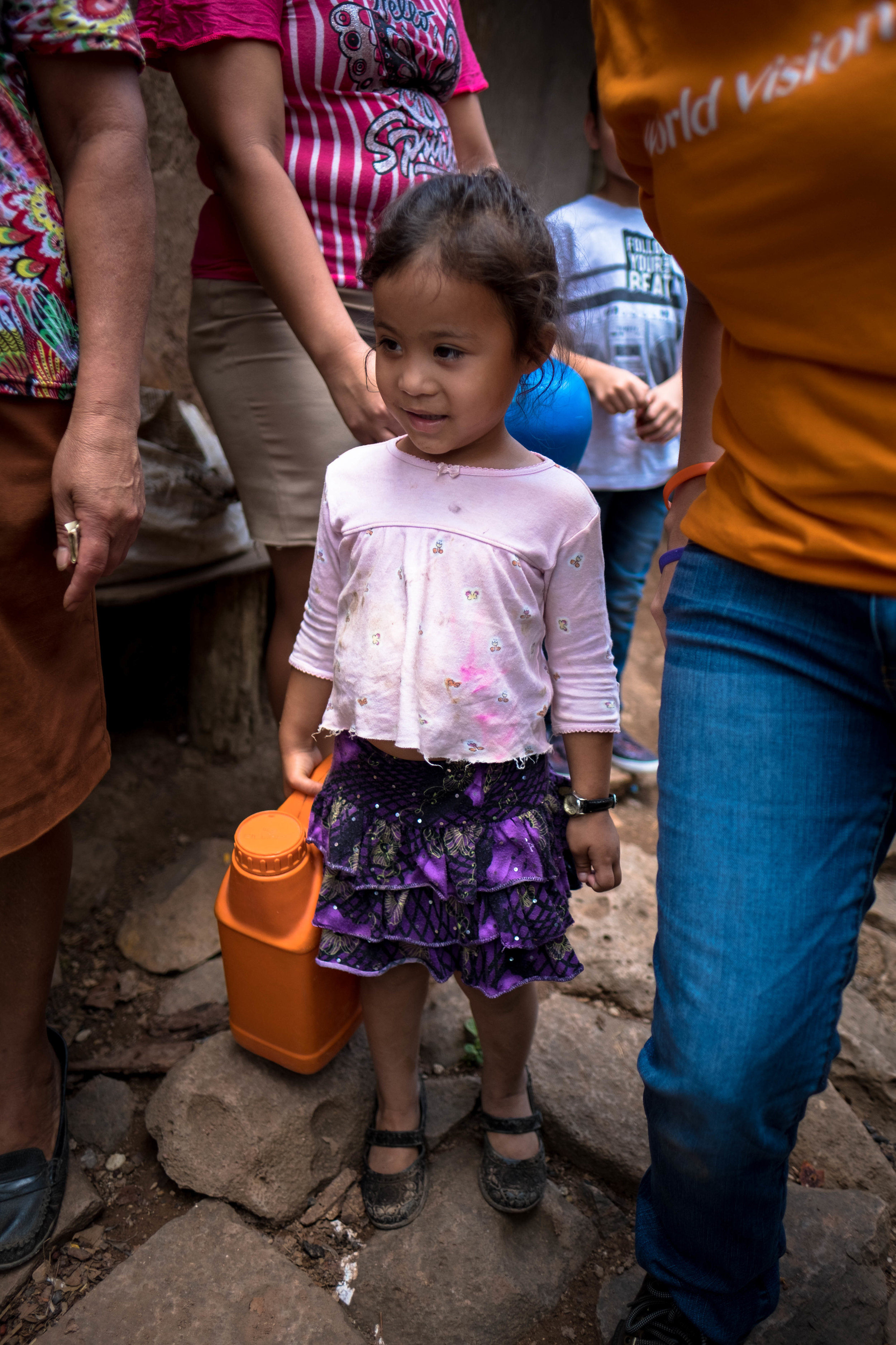 Honduras 18 day 2_little girl holds water container.jpg