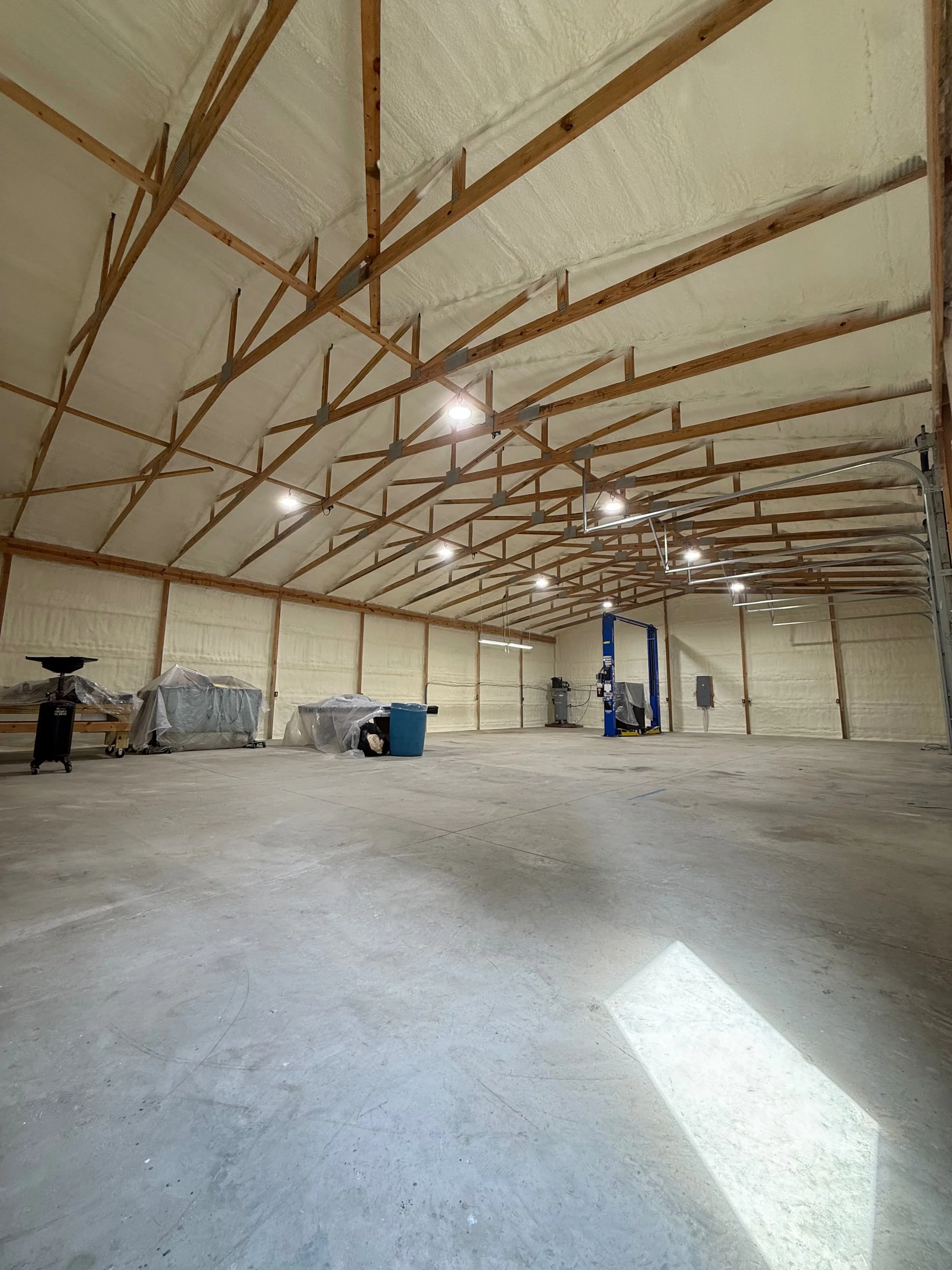 spray foam insulation completed on walls and ceiling of a large commercial building with overhead garage door — Summit Sprayfoam, central Ohio