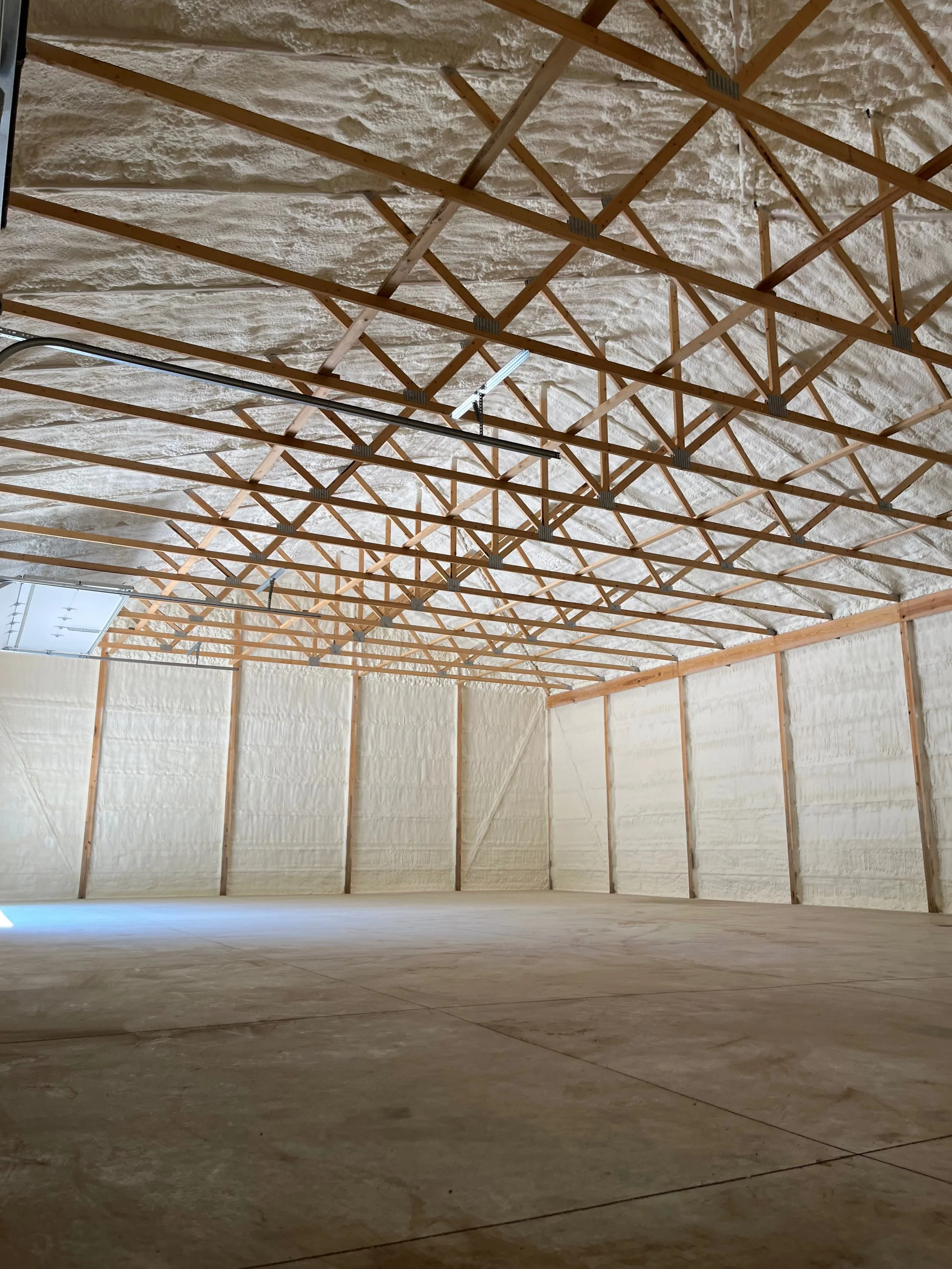 spray foam insulation covering roof trusses and all interior walls of a large residential garage — Summit Sprayfoam, central Ohio