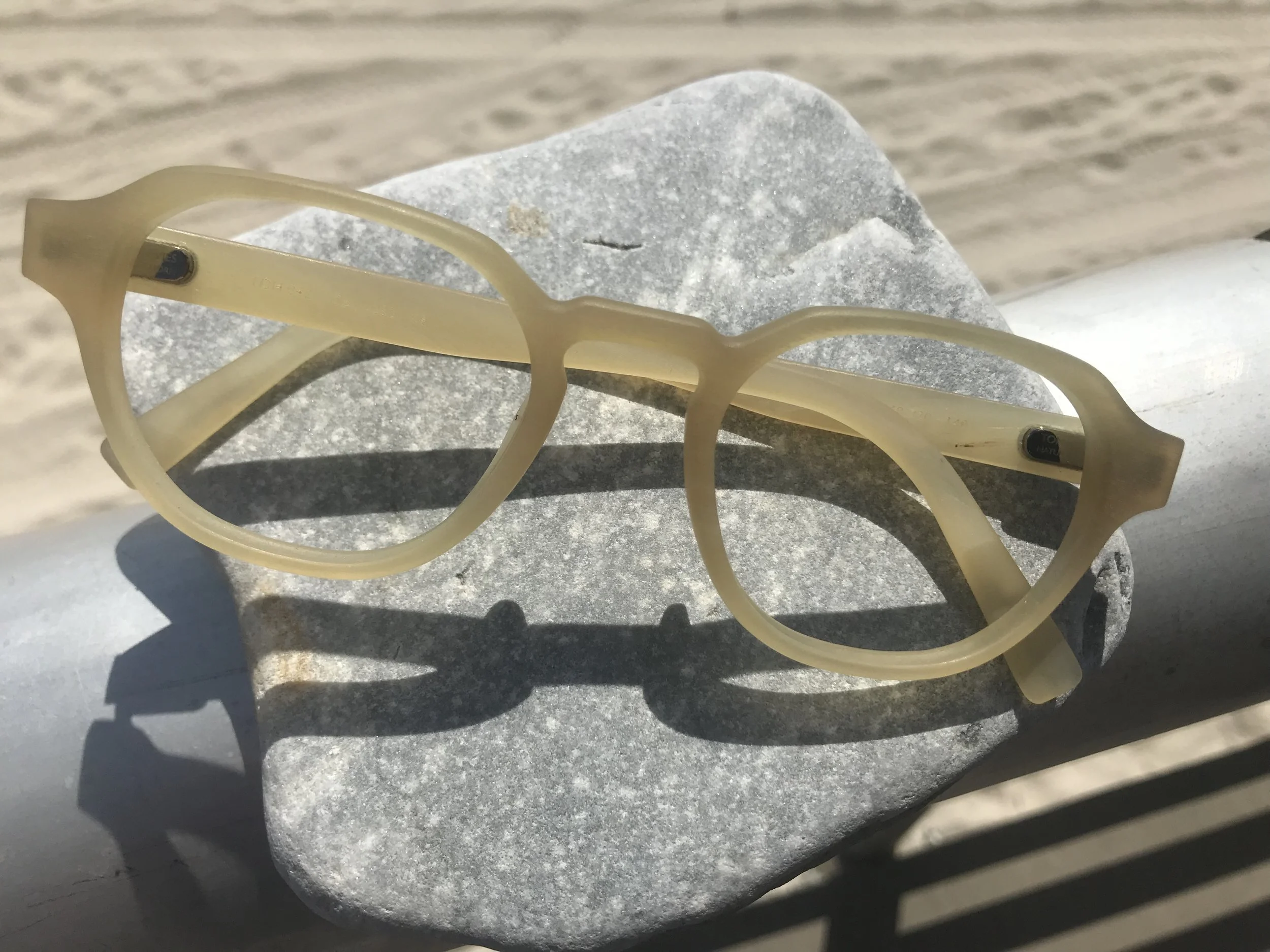 Cream colored buffalo horn frame top view at the beach
