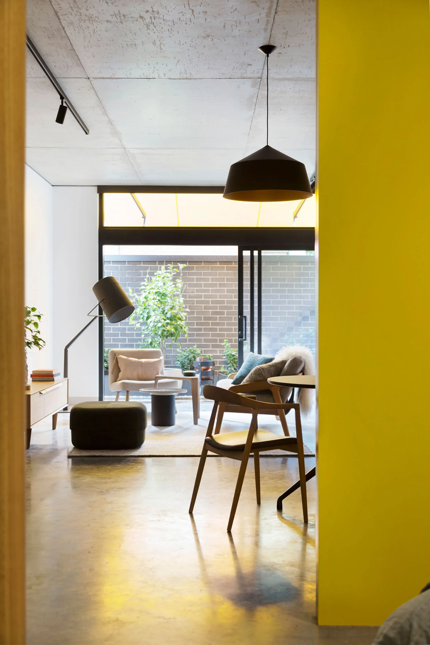 Large black Circus pendant designed by Corinna Warm for Studio Warm at Coppin Street apartments by Musk Architecture
