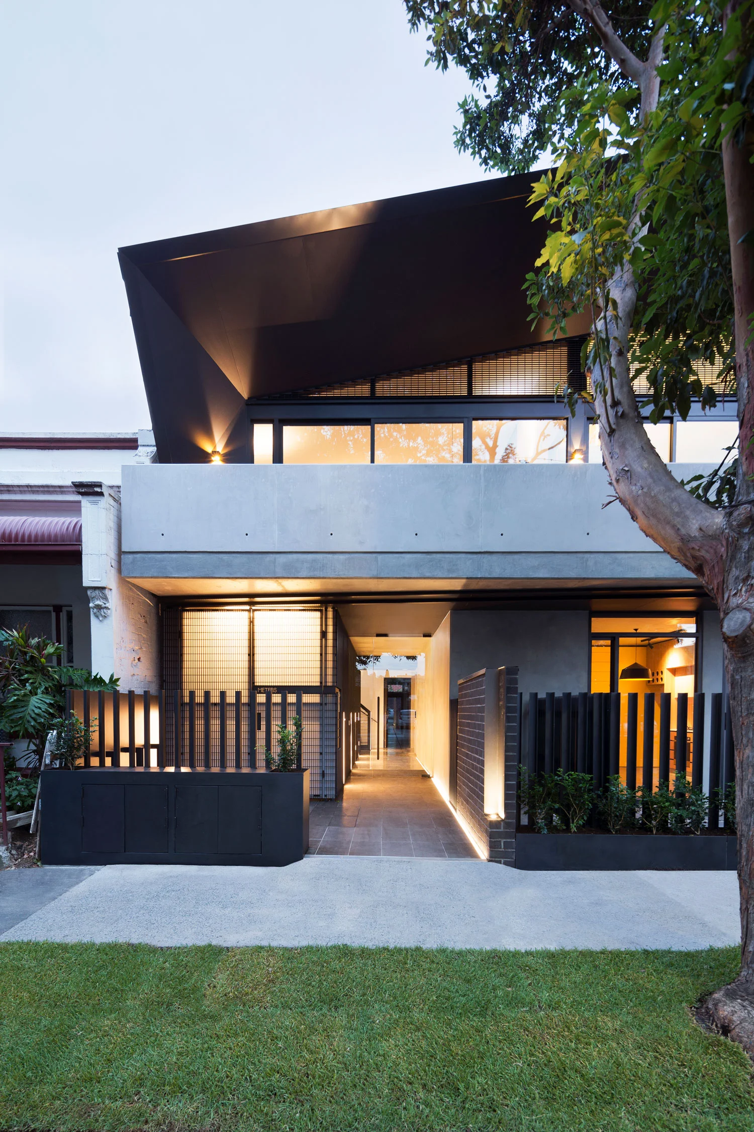 Large black Circus pendant designed by Corinna Warm for Studio Warm at Coppin Street apartments by Musk Architecture