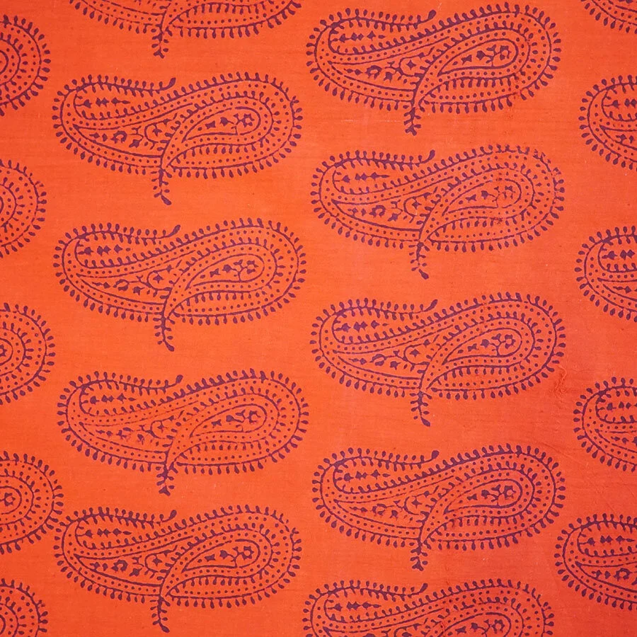 Orange/red fabric with paisley print