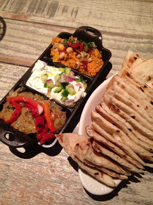 Roasted pepper and garlic eggplant dip, cucumber dill yogurt, and sundried tomato and herb hummus with pita