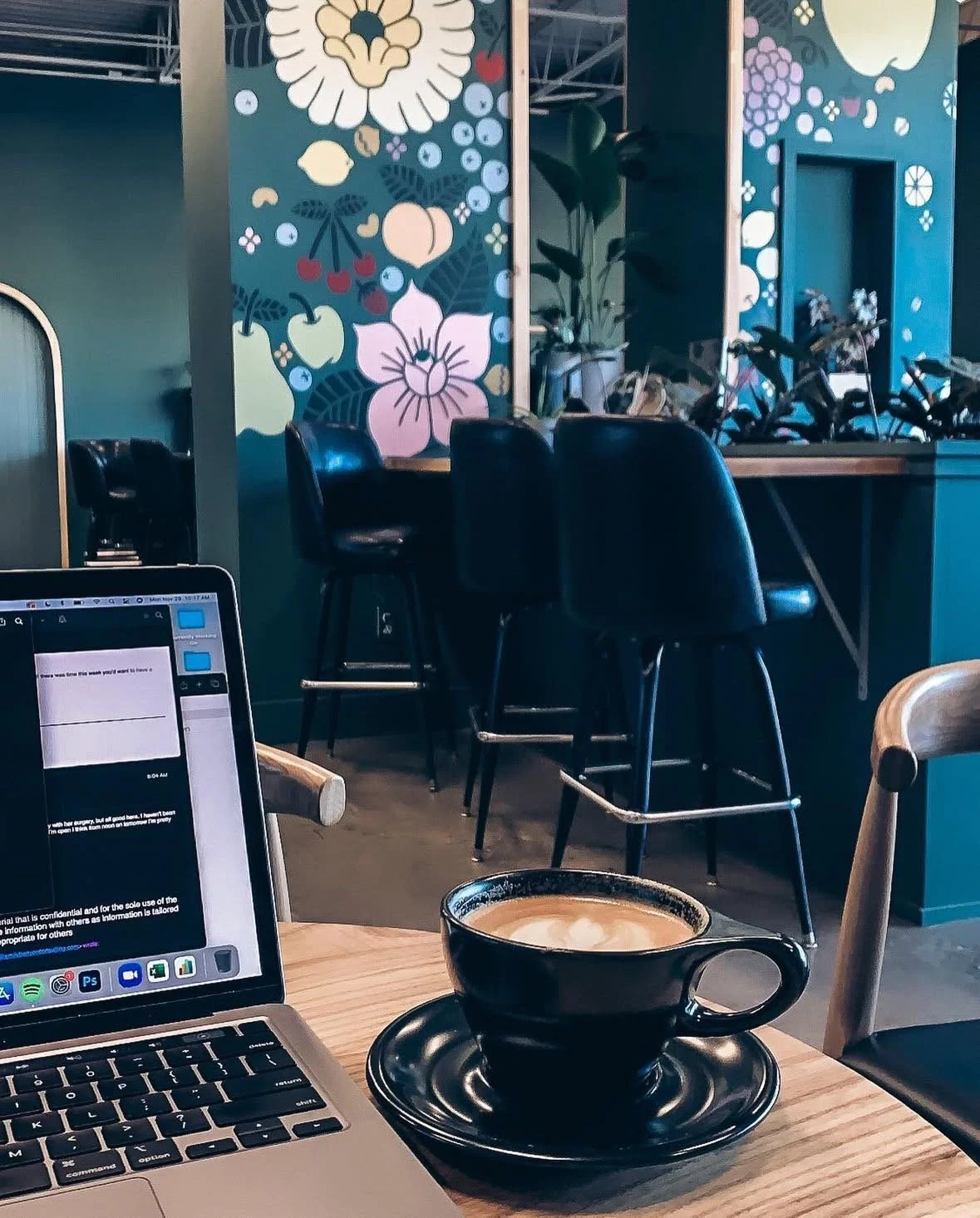 Latte and laptop on table at Three Ships Coffee Hilltop