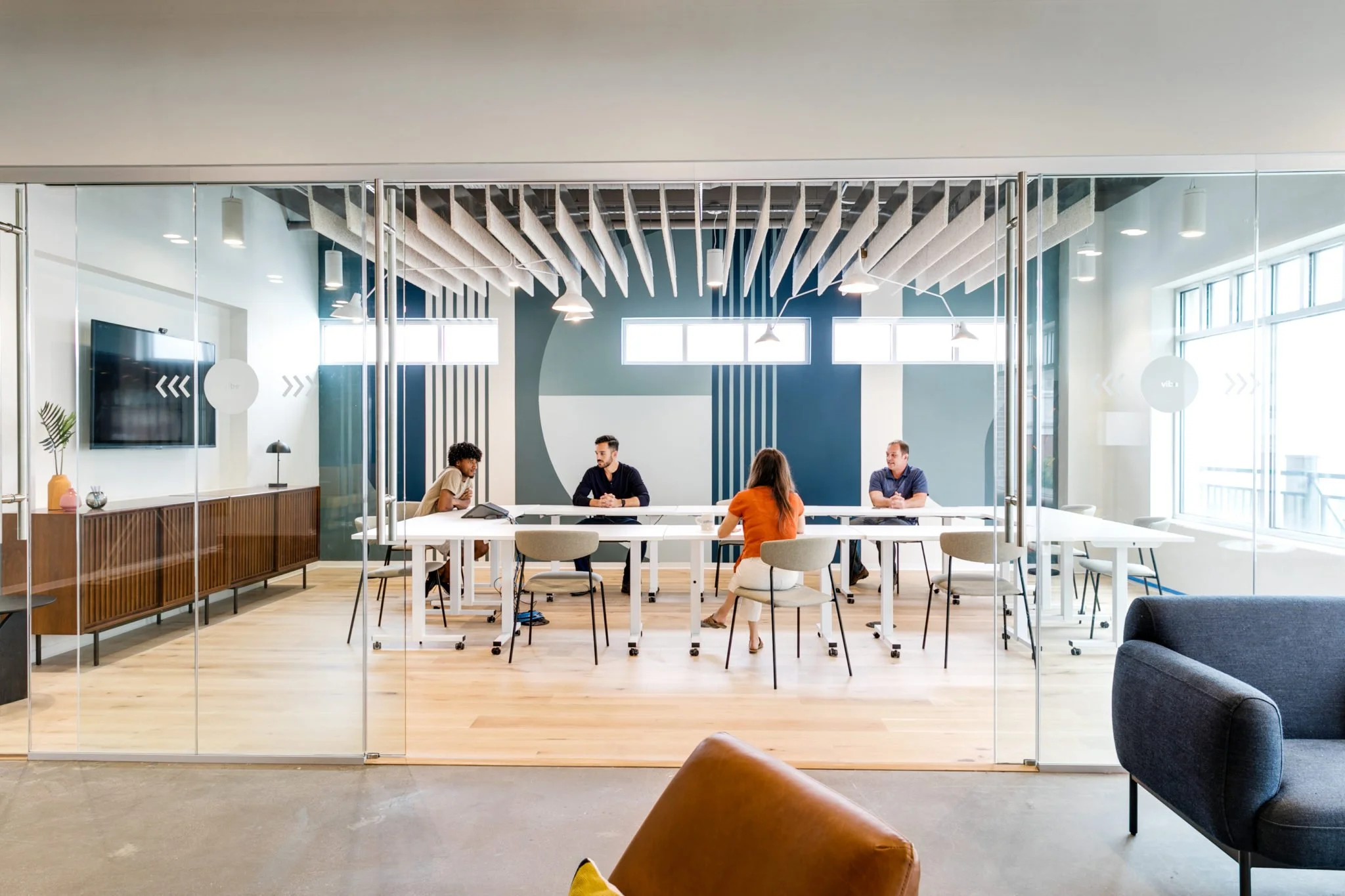 Four people inside conference room at Gather VB