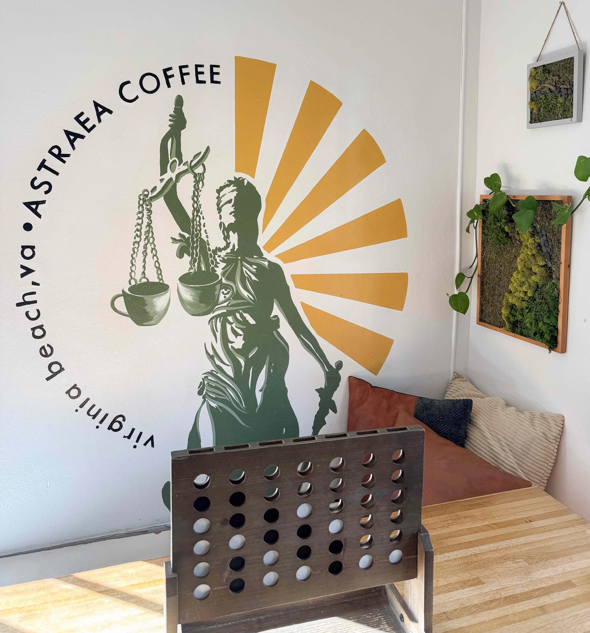 Astraea coffee shop mural behind table with game on it