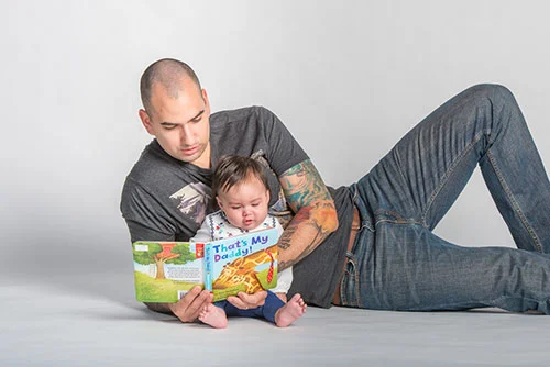 Father reading book to baby