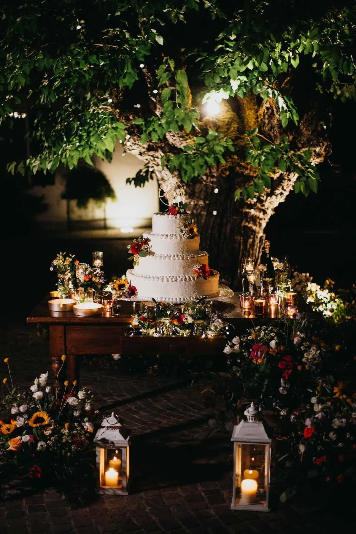Taglio della torta sotto l’albero a Villa Garibalda con lucine calde