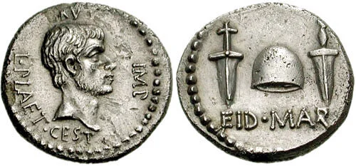 EID MAR Denarius. Brutus sanctioned this coin in 43/42 BCE. It depicts him one one side (it was seen as ‘kingly’ to have your likeness on a coin while living…way to be a contradiction there, Brute), with the liberty cap between daggers on the other.…