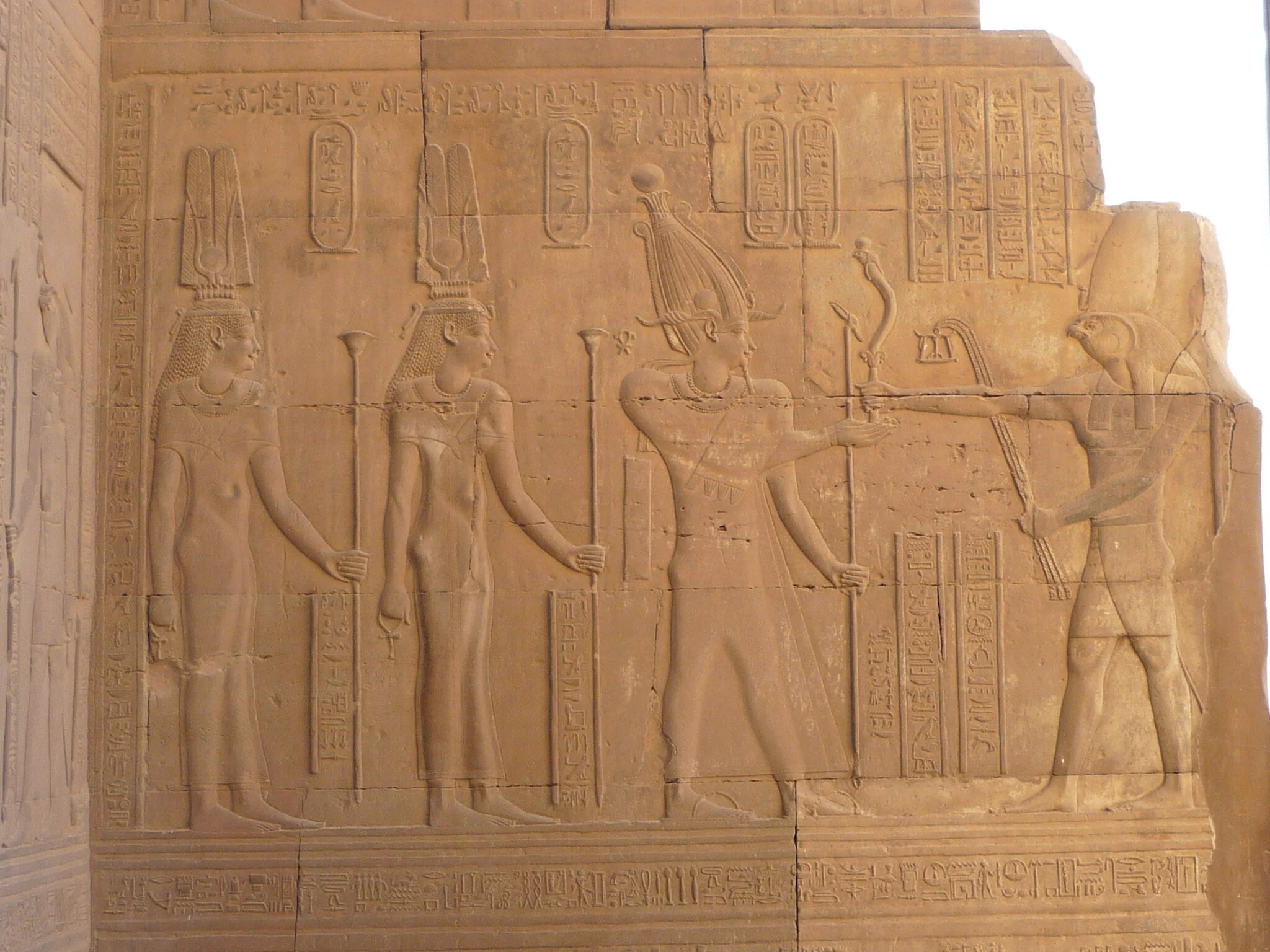 An Egyptian wall relief showing Cleopatra III, Cleopatra II, and Ptolemy VIII before Horus. Just your average incestuous threesome. Wikicommons.