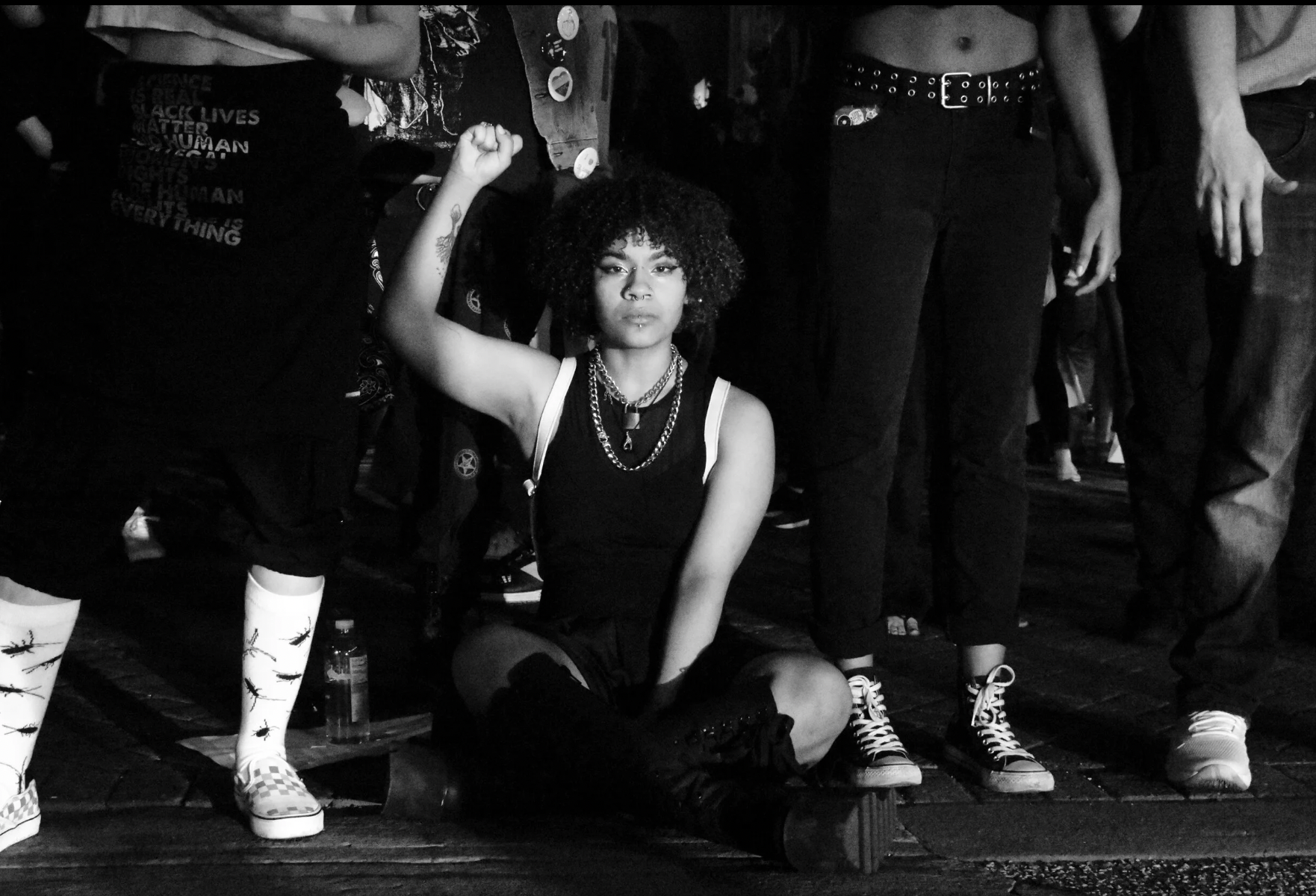 Woman sitting with fist raised