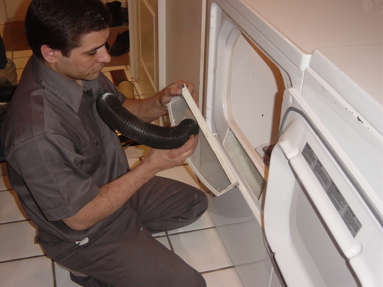 The lint screen is inspected for damage and carefully cleaned.