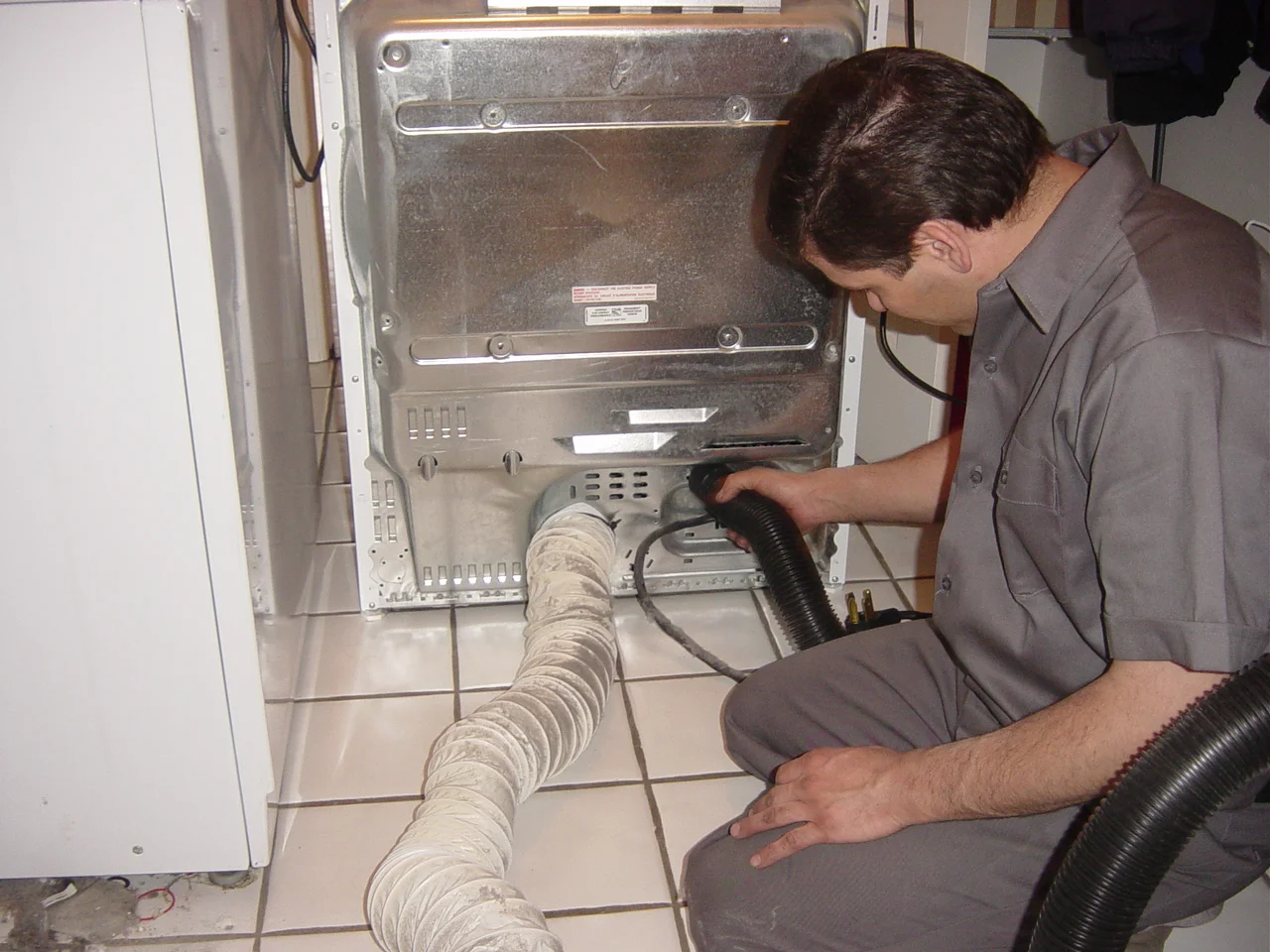 The picture above shows a plastic flex duct attached to the back of the dryer. This type of flex duct is very flammable and must never by used in any area of your dryer vent system. If we notice any plastic duct, we will advise you and recommend changing it.