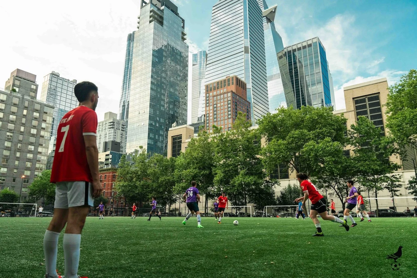 NYC Footy soccer game at Battery Park urban field with high-rise buildings in background