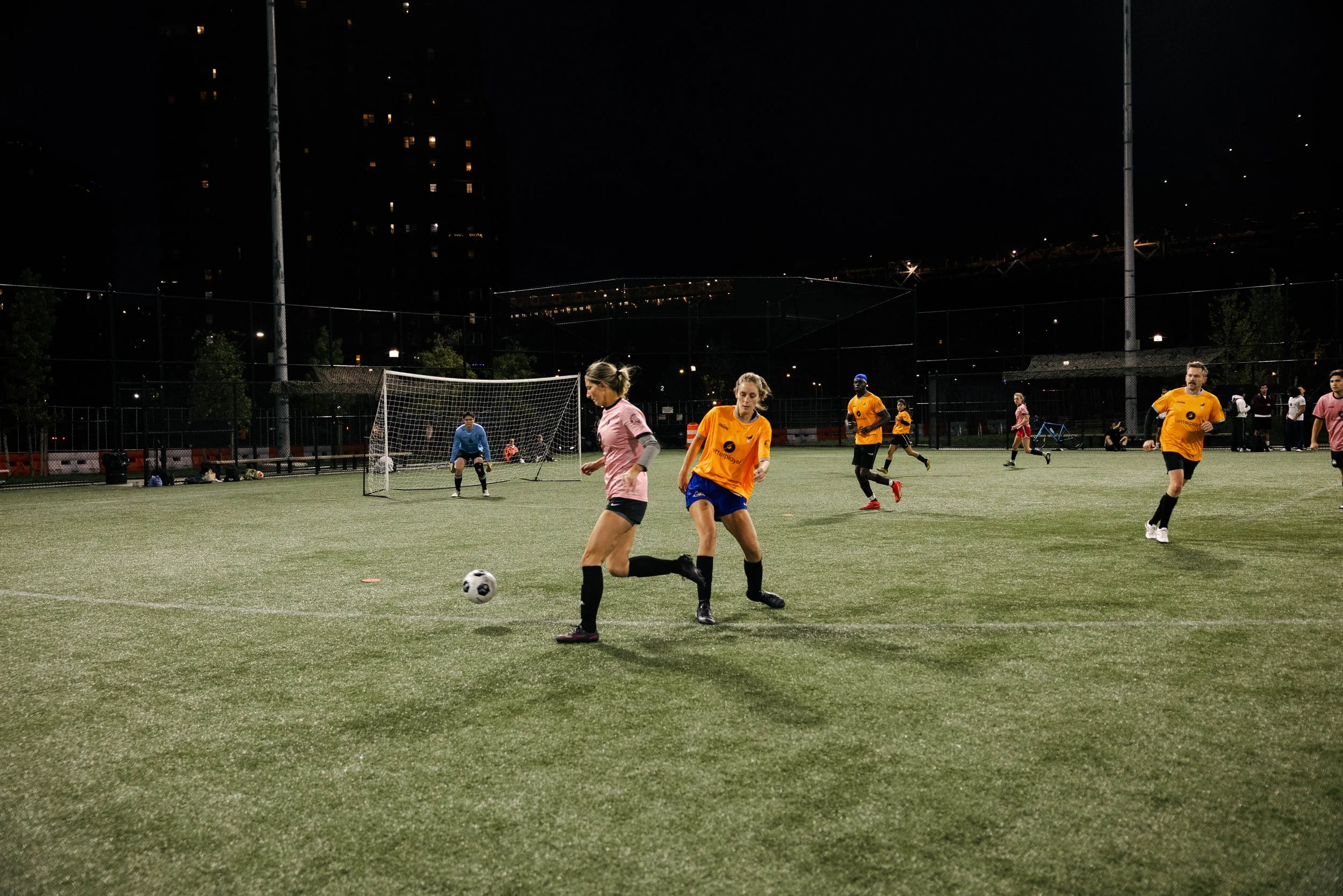 A Soccer Field Under a Bridge with NYC Footy Players