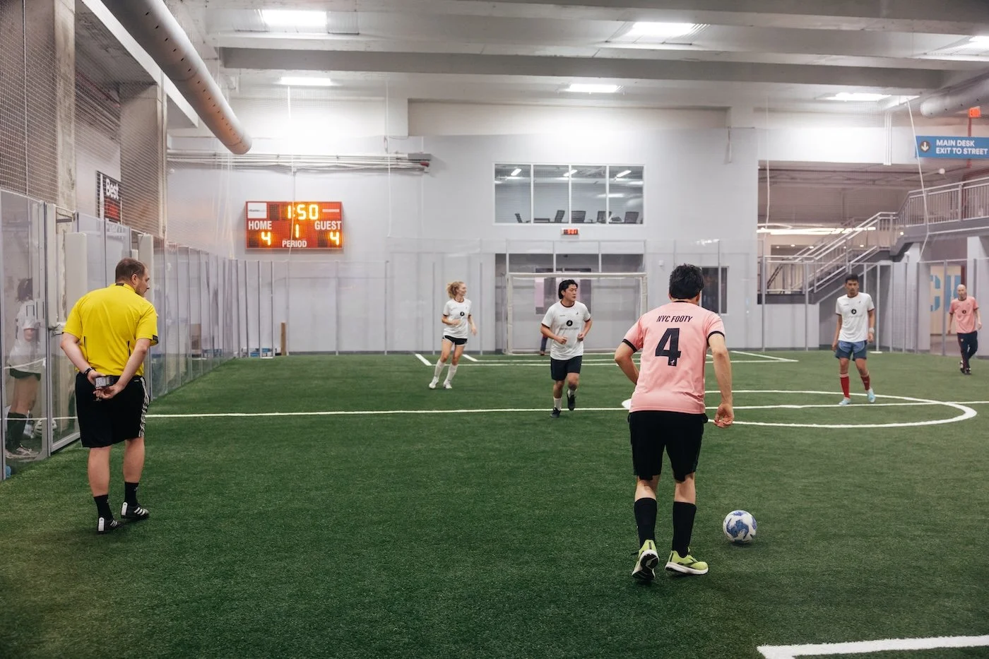 NYC Footy female players huddling on a soccer field