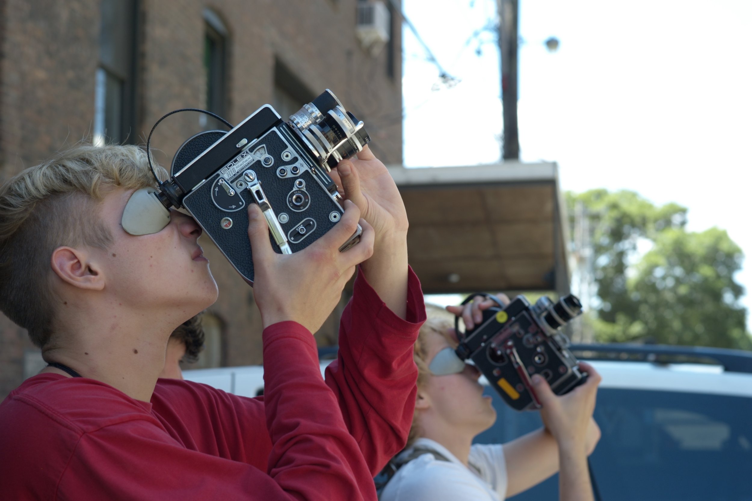  High school students participating in a 16mm Bolex camera workshop at AgX. 