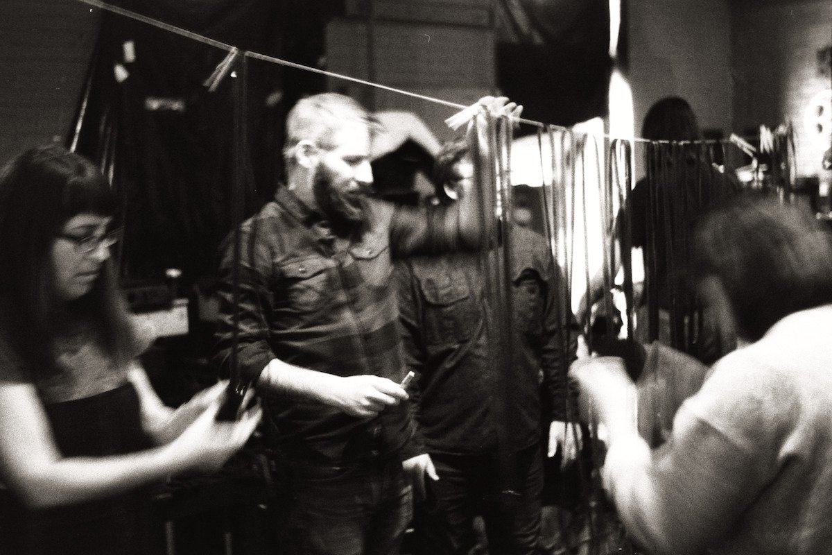  AgX members hanging hand-processed film to dry outside of the darkroom. 