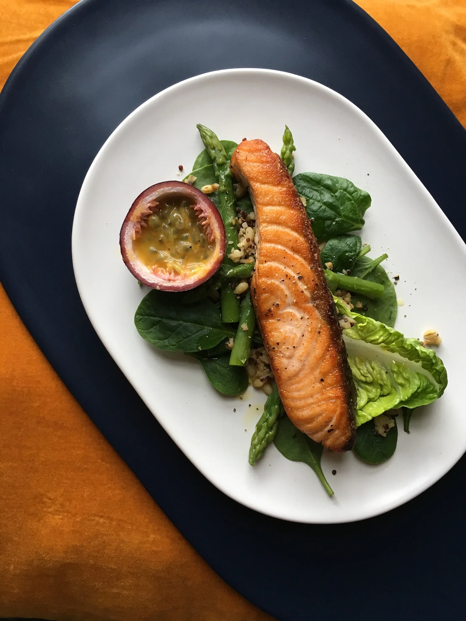 Salmon, quinoa, asparagus, spinach and passion fruit dressing