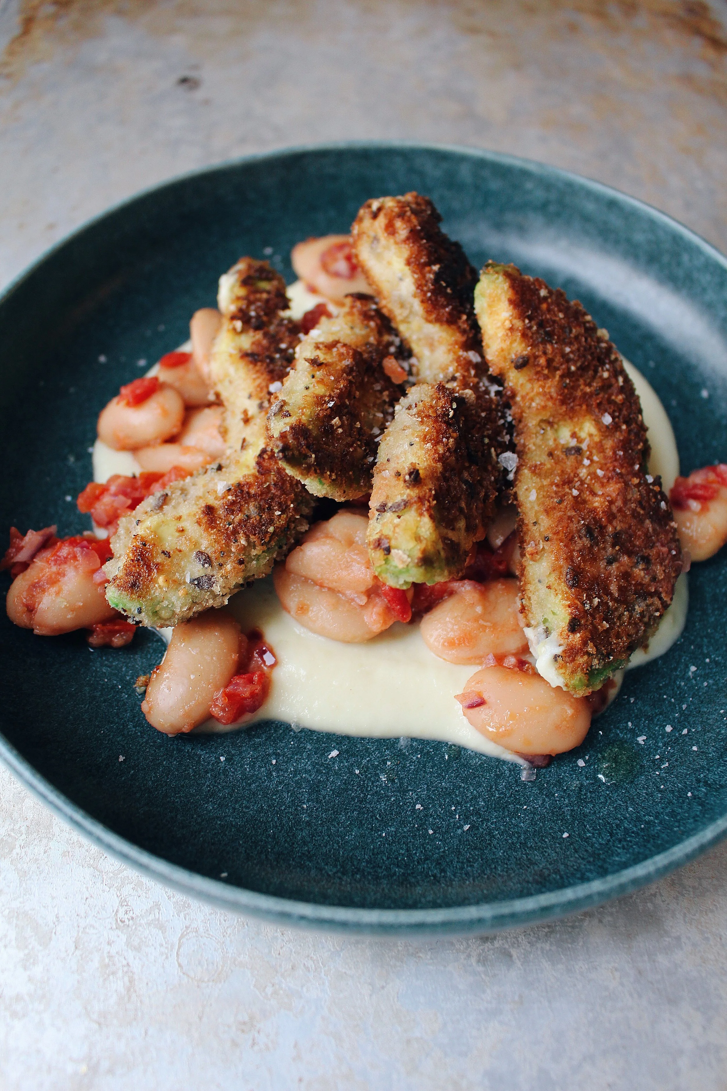Baked breaded avocado fries, tomato and red onion compote,   spiced parsnip purée