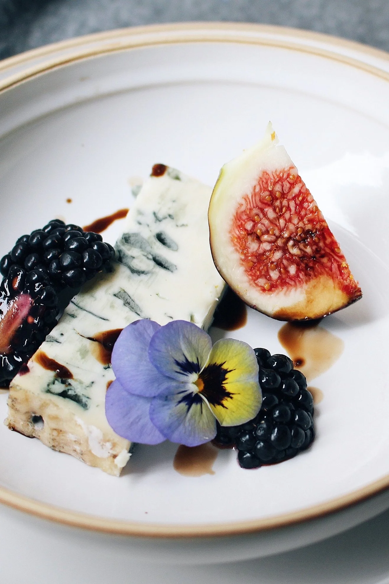 Gorgonzola, blueberries, fig, edible flower, balsamic vinegar reduction.