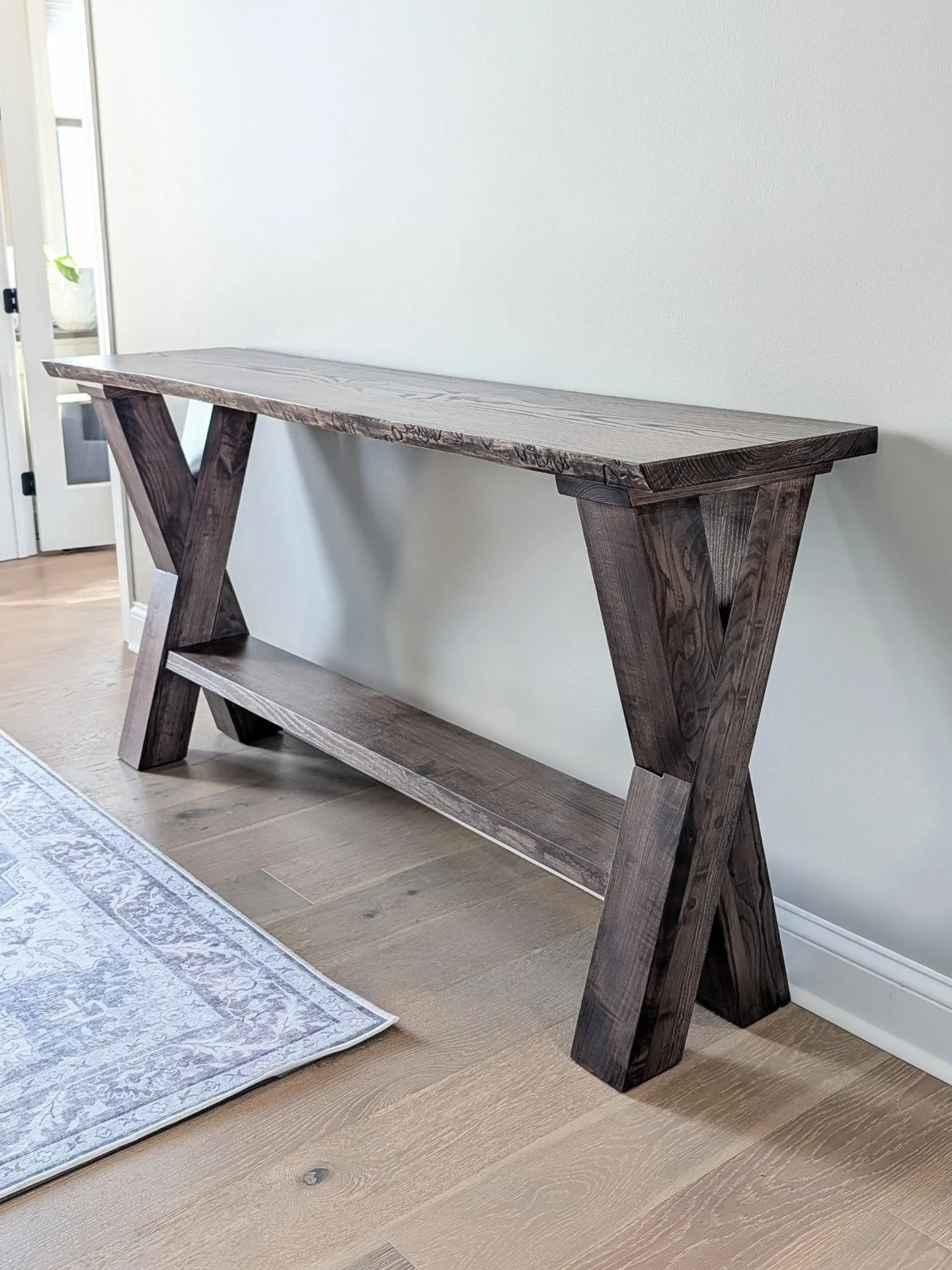 We delivered this custom entry table to a beautiful new home in Fishers. 

This piece was constructed from a set of Ash slabs from the same log. Fun angles, challenging laps, and classy lines!

Solid Ash
Chocolate Brownie Stain
72" x 18" x 