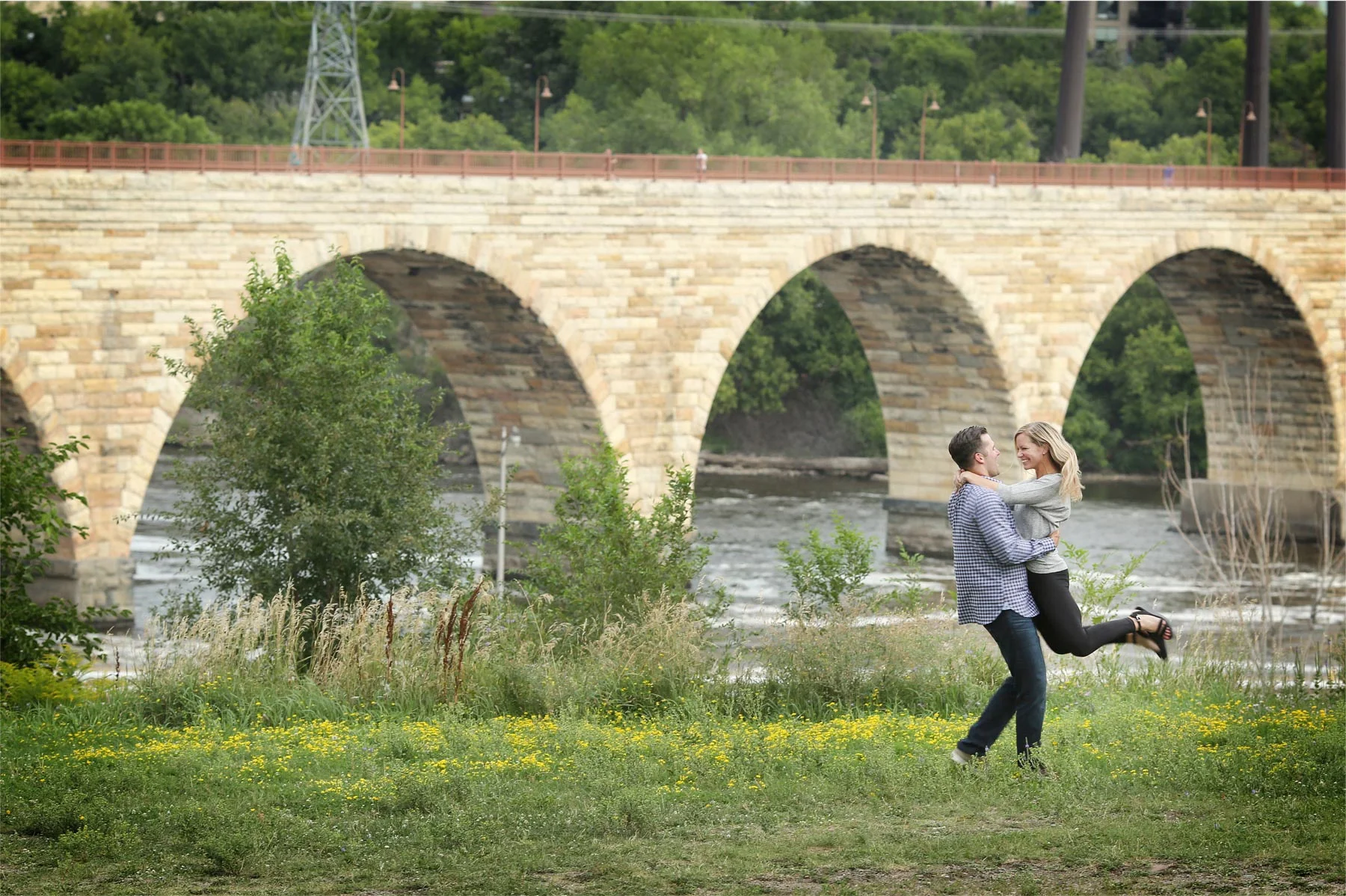 13-Minneapolis-Minnesota-Engagement-Photographer-by-Andrew-Vick-Photography-Summer-Mississippi-River-Stone-Arch-Bridge-Twirling-Tina-and-Kevin.jpg