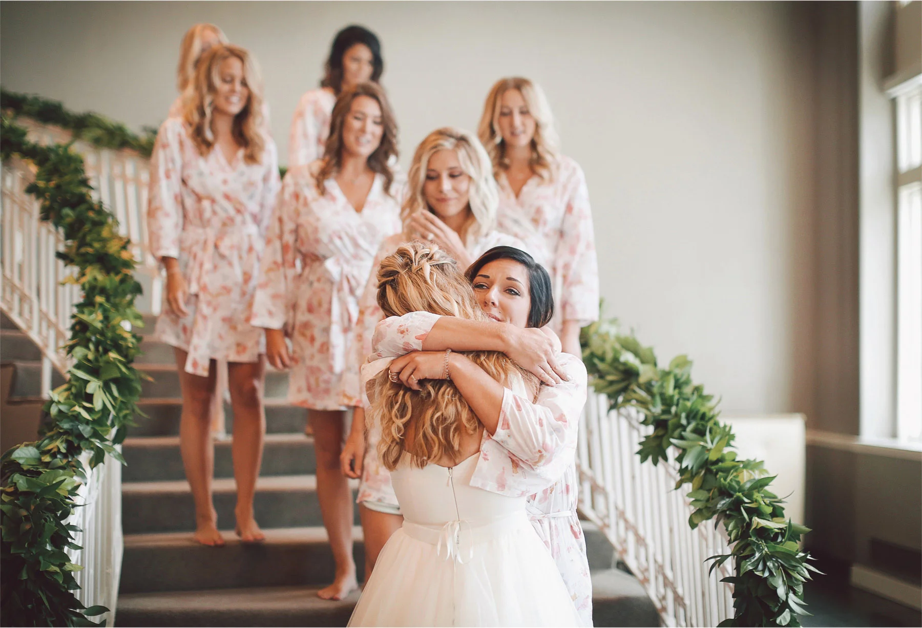 03-Minneapolis-Minnesota-Wedding-Photographer-by-Andrew-Vick-Photography-Summer-Calhoun-Beach-Club-Getting-Ready-Bride-Bridesmaids-Reveal-Staircase-Stairs-Hug-Lexie-and-James.jpg