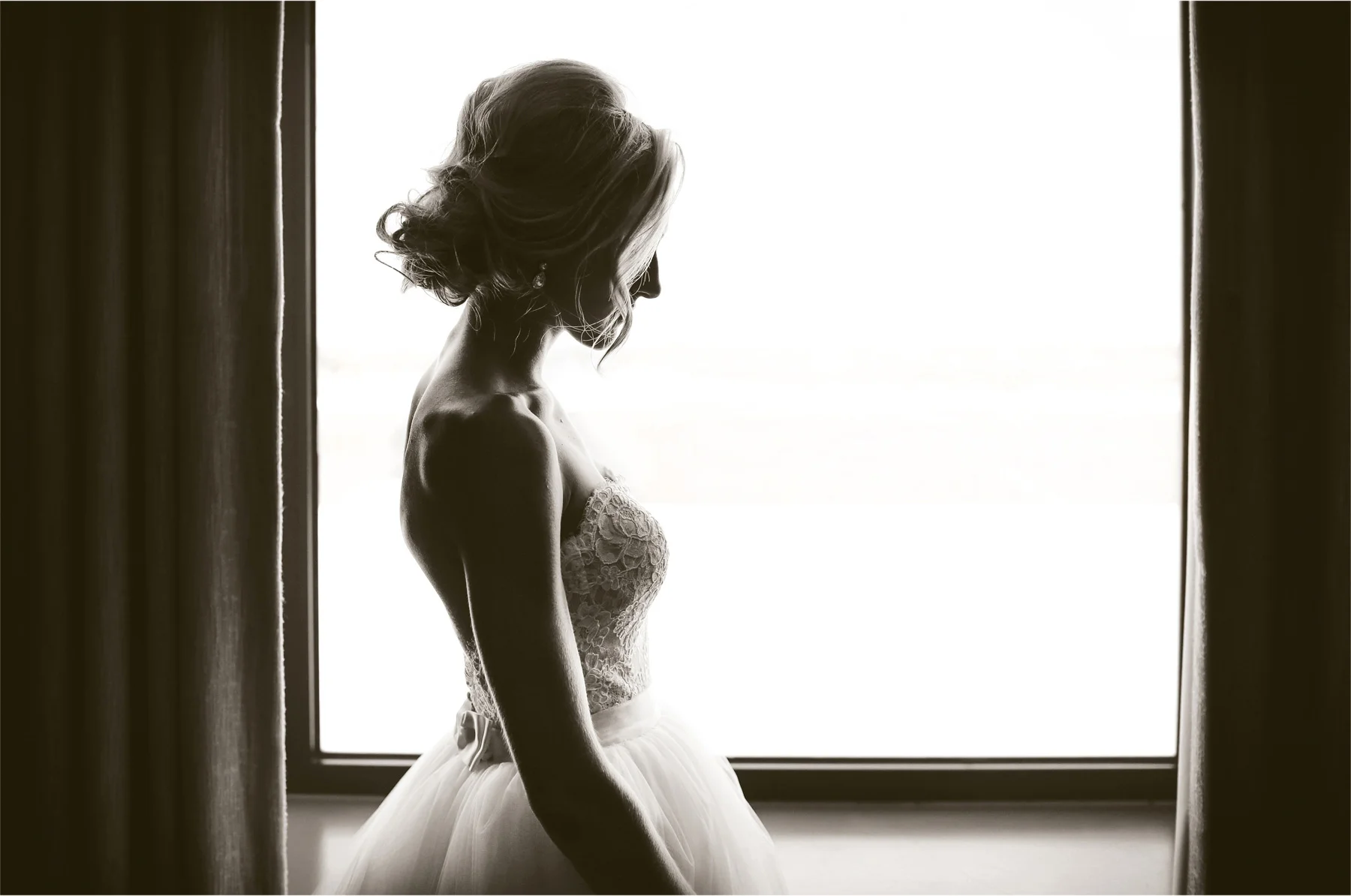 04-Minneapolis-Minnesota-Wedding-Photographer-by-Andrew-Vick-Photography-Summer-Lowes-Hotel-Getting-Ready-Bride-Dress-Sepia-Emily-and-Jay.jpg