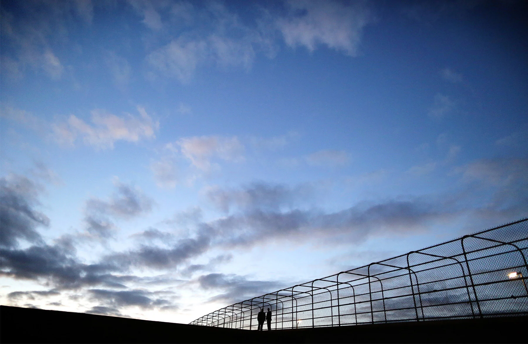 17-Minneapolis-Minnesota-Wedding-Photographer-by-Andrew-Vick-Photography-Fall-Autumn-Pedestrian-Bridge-Groom-Silhouette-Night-Sky-Sunset-Ben-and-Adam.jpg