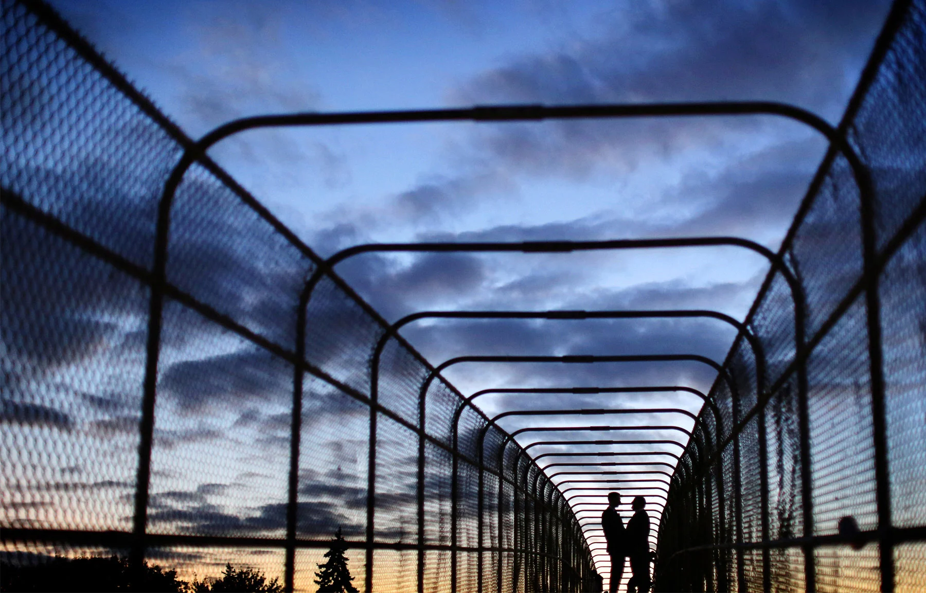 18-Minneapolis-Minnesota-Wedding-Photographer-by-Andrew-Vick-Photography-Fall-Autumn-Pedestrian-Bridge-Groom-Silhouette-Night-Sky-Sunset-Ben-and-Adam.jpg