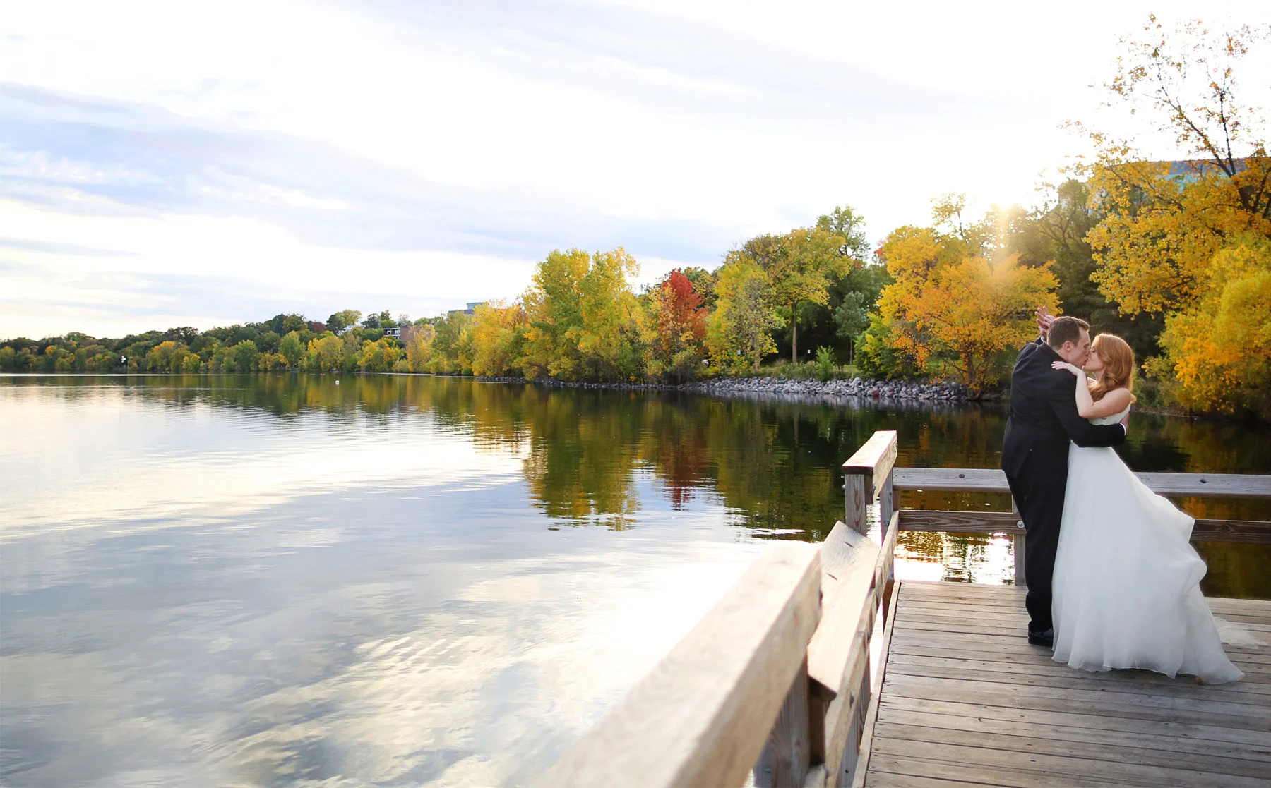 23-Minneapolis-Minnesota-Wedding-Photographer-by-Andrew-Vick-Photography-Fall-Autumn-Lake-Calhoun-Bride-Groom-Dock-Kiss-Kristy-and-Jack.jpg