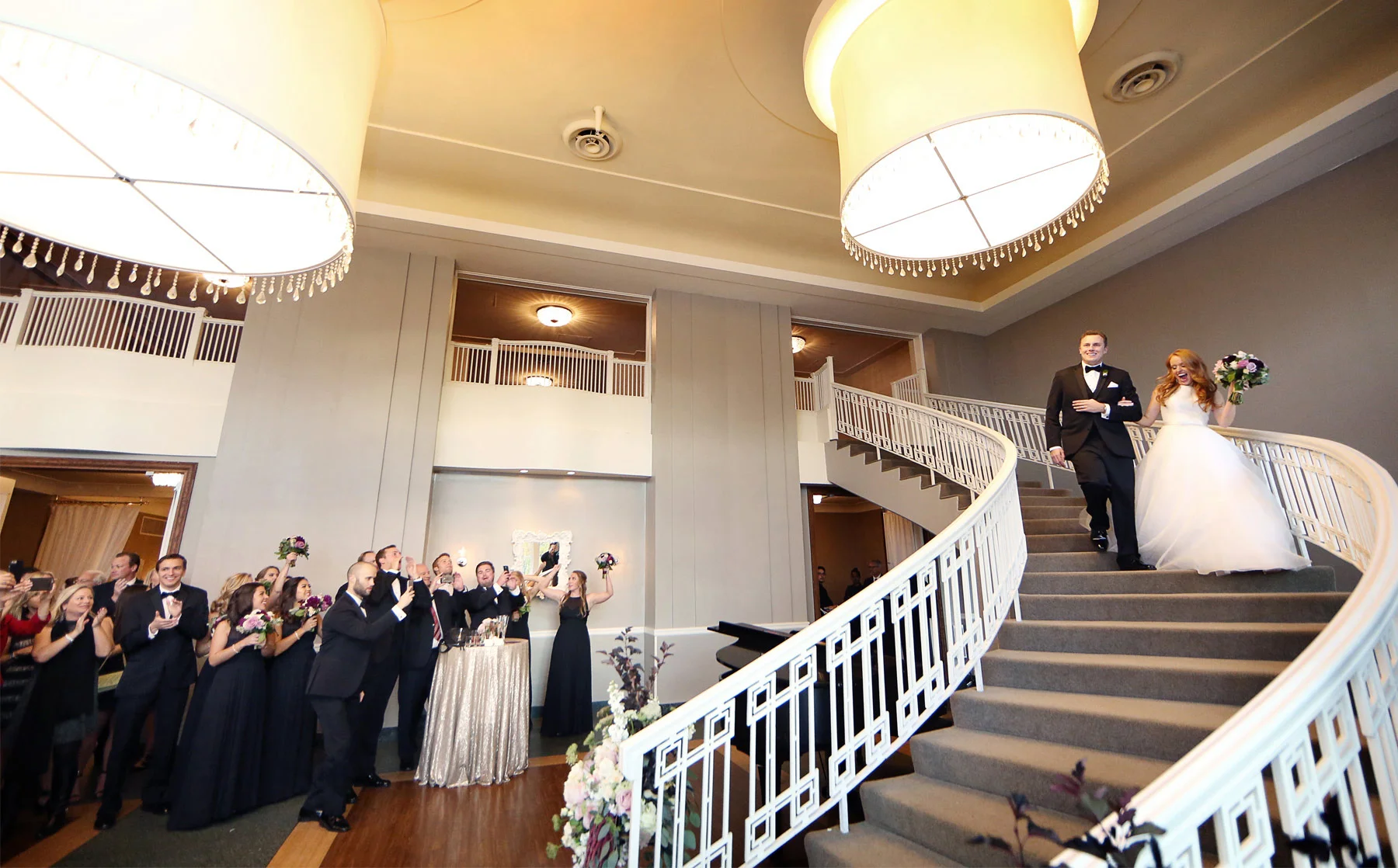 26-Minneapolis-Minnesota-Wedding-Photographer-by-Andrew-Vick-Photography-Fall-Autumn-Calhoun-Beach-Club-Reception-Bride-Groom-Grand-March-Guests-Staircase-Stairs-Kristy-and-Jack.jpg