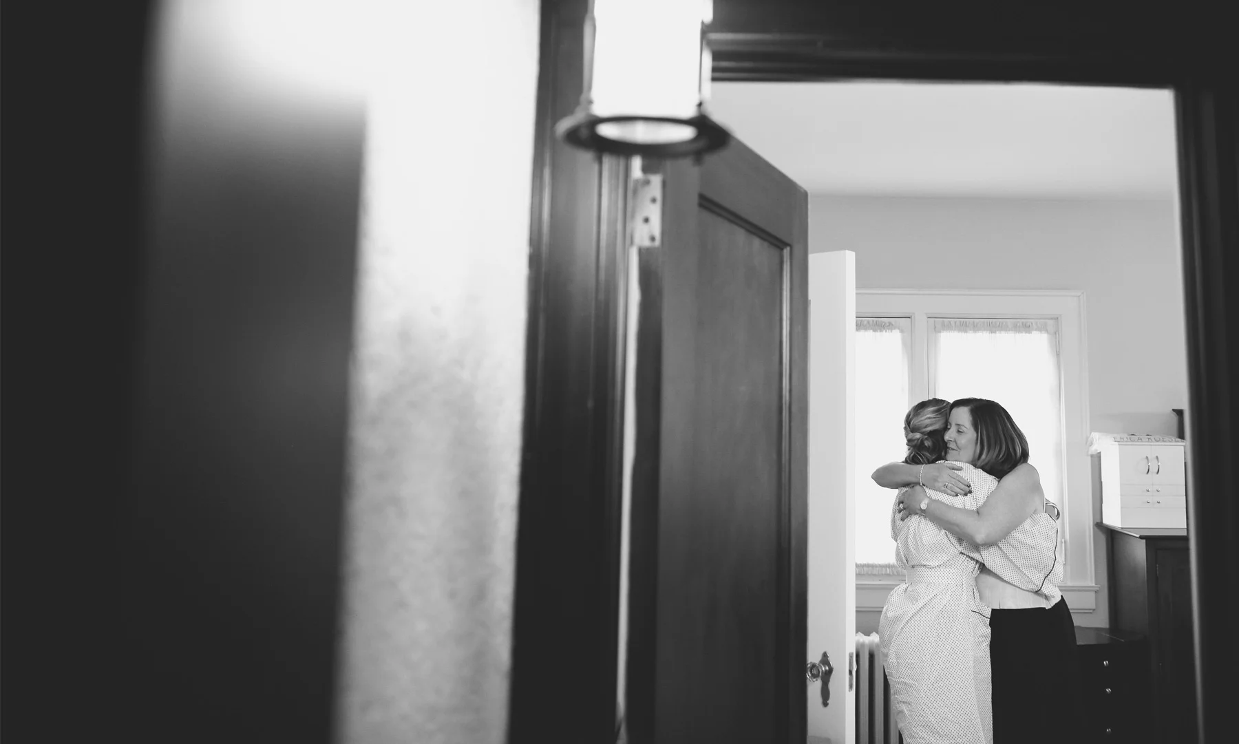 01-Saint-Paul-Minnesota-Wedding-Photographer-by-Andrew-Vick-Photography-Fall-Autumn-Parents-House-Getting-Ready-Bride-Mother-Embrace-Hug-Black-and-White-Kathryn-and-Sam.jpg