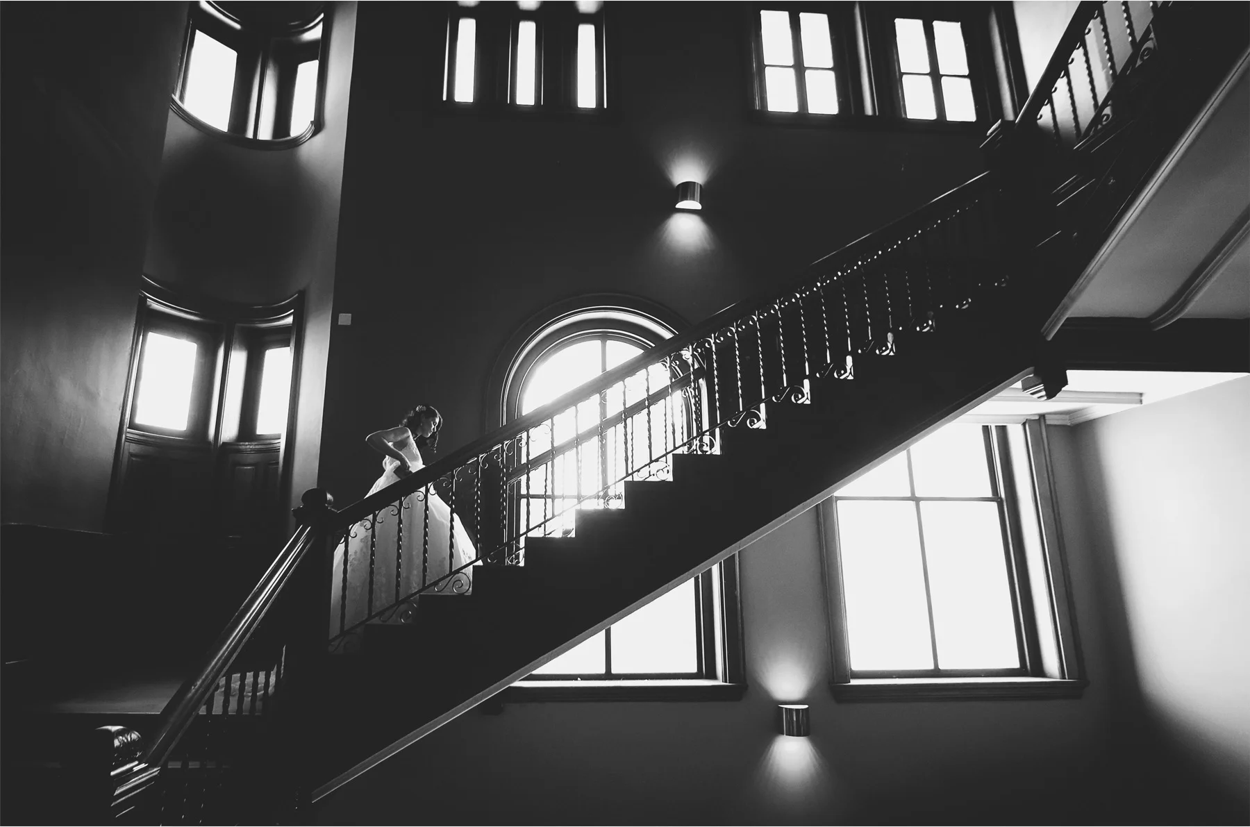 05-Saint-Paul-Minnesota-Wedding-Photographer-by-Andrew-Vick-Photography-Winter-New-Years-Eve-Embassy-Suites-First-Meeting-Look-Bride-Staircase-Stairs-Black-and-White-Emily-and-Michael.jpg