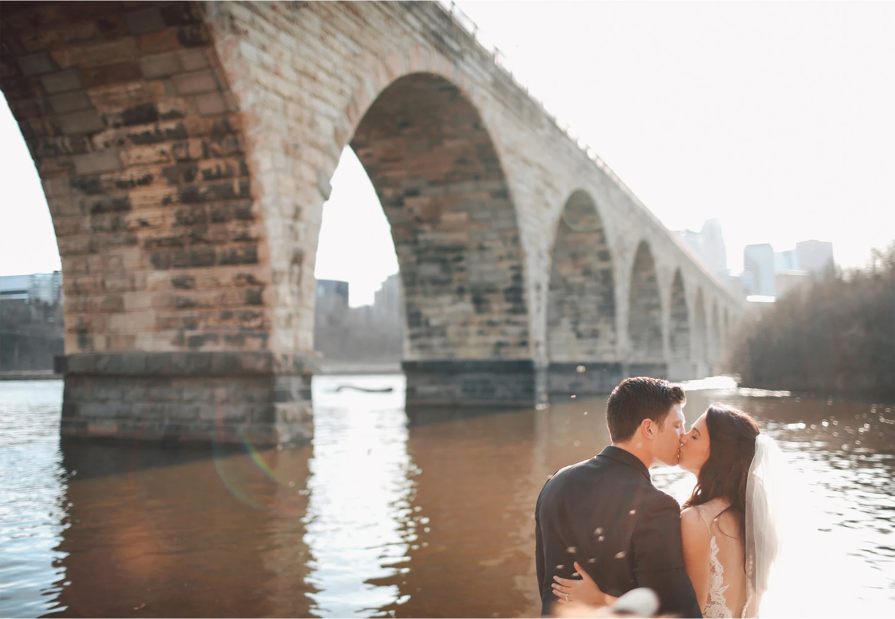 16-Minneapolis-Minnesota-Wedding-Photographer-by-Andrew-Vick-Photography-Stone-Arch-Bridge-Spring-Bride-Groom-Kiss-Mississippi-River-Vintage-Laughter-Alex-and-Andy.jpg