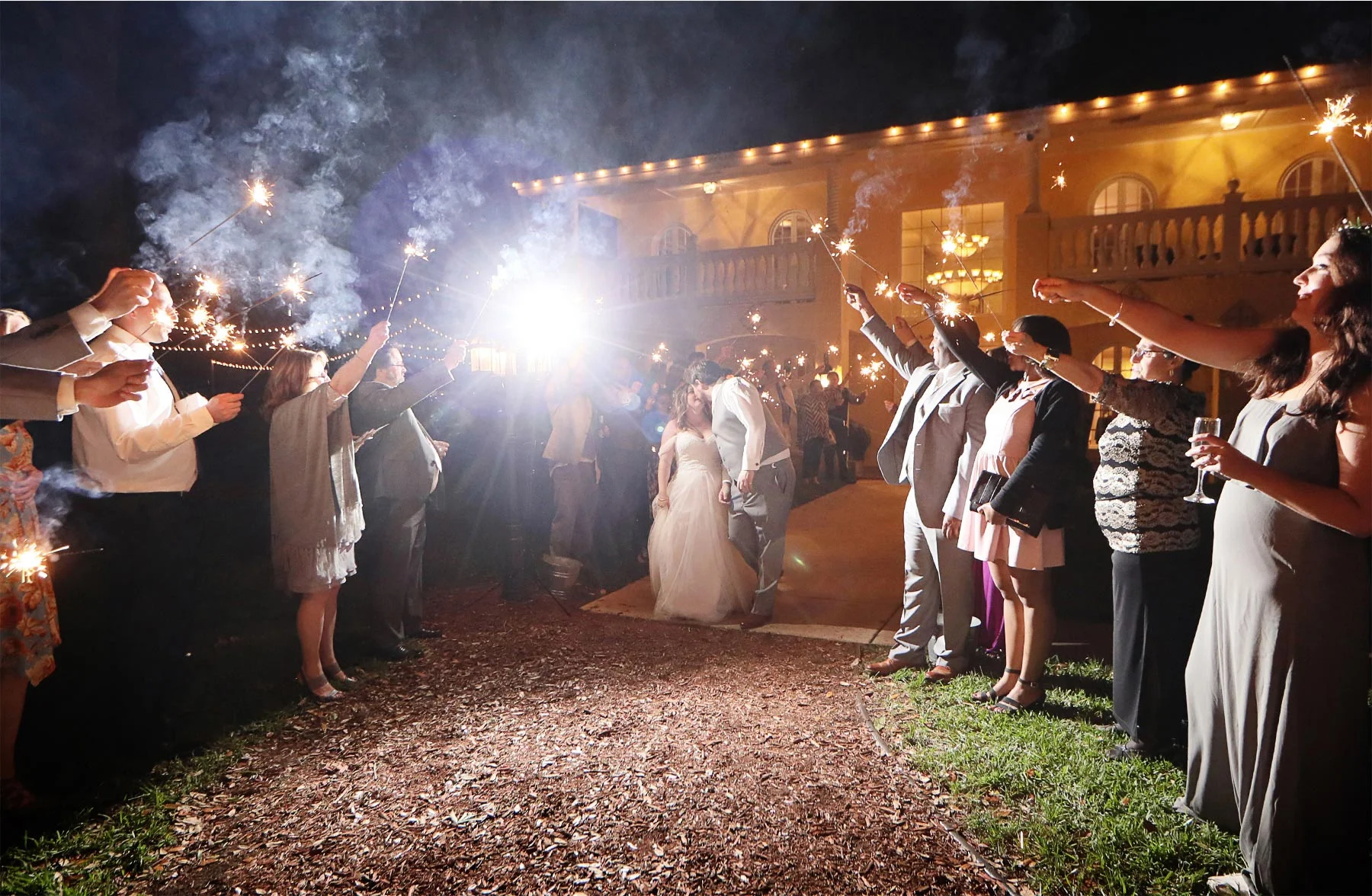 29-Brandon-Florida-Wedding-Photographer-by-Andrew-Vick-Photography-Casa-Lantana-Spring-Reception-Bride-Groom-Guests-Kiss-Sprakler-Sendoff-Night-Kristianna-and-Ben.jpg