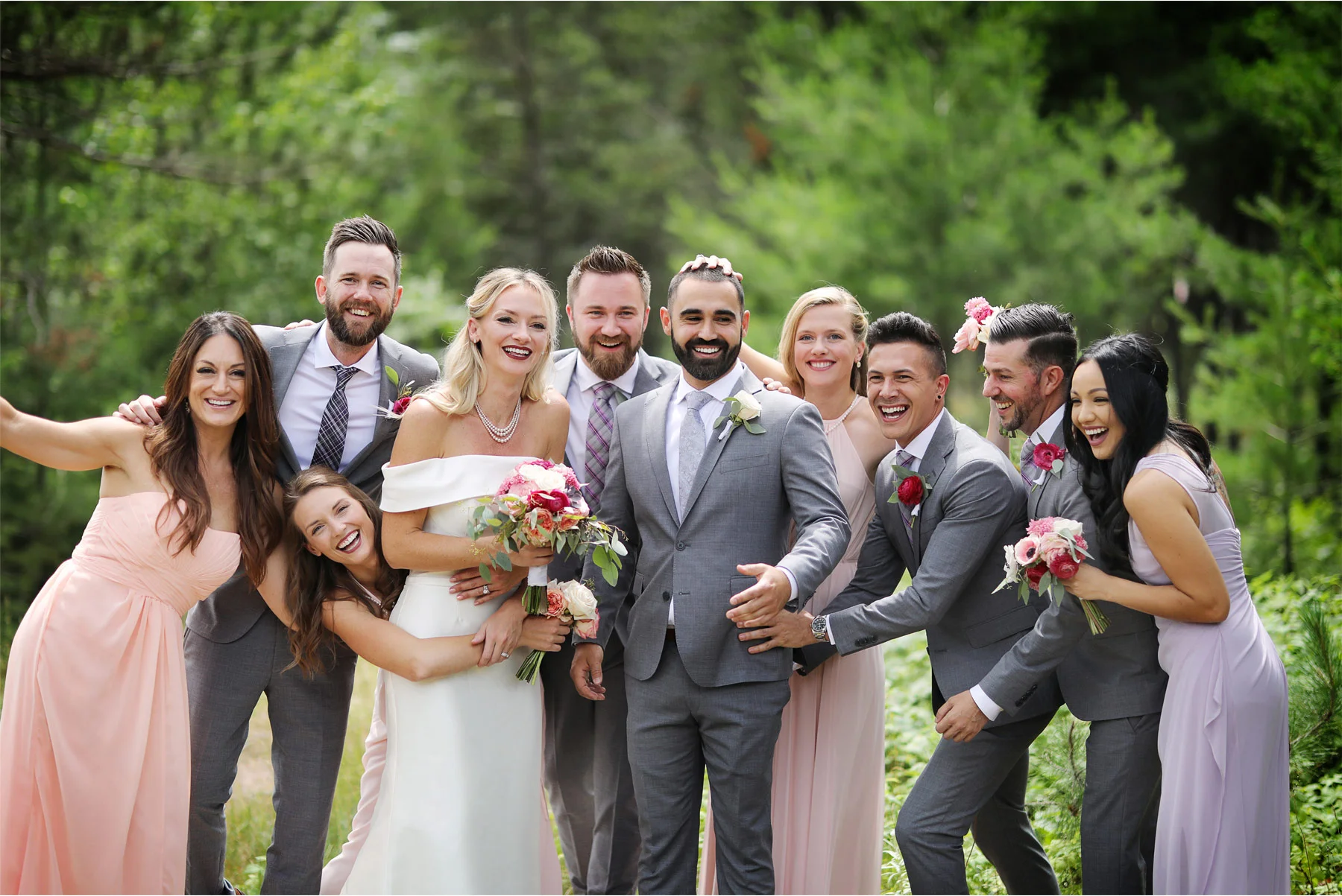 09-Ely-Minnesota-North-Wedding-by-Andrew-Vick-Photography-Bridesmaids-Groomsmen-Laughing-Katie-and-Joe.jpg