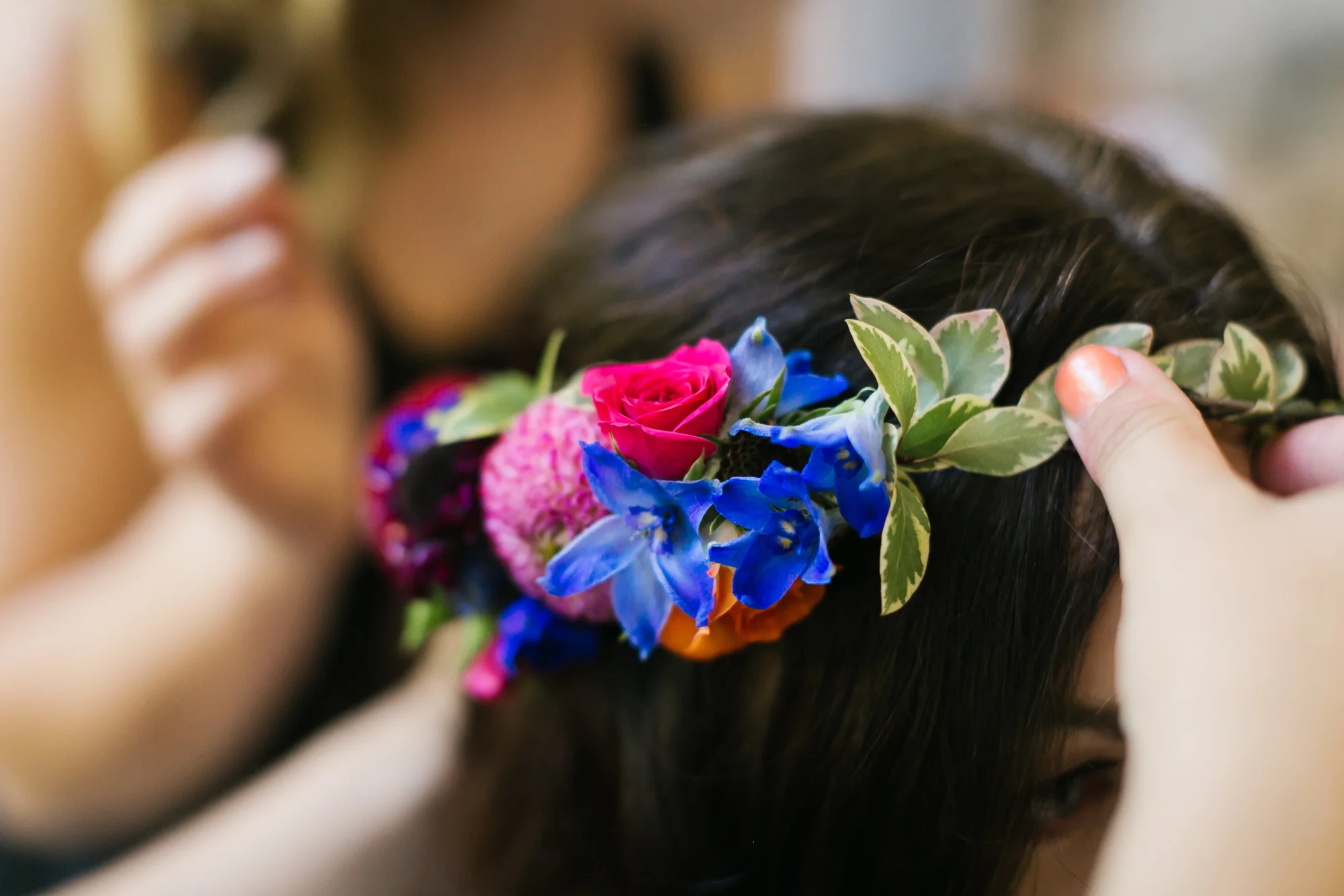 Bride's floral crown as it's being put on
